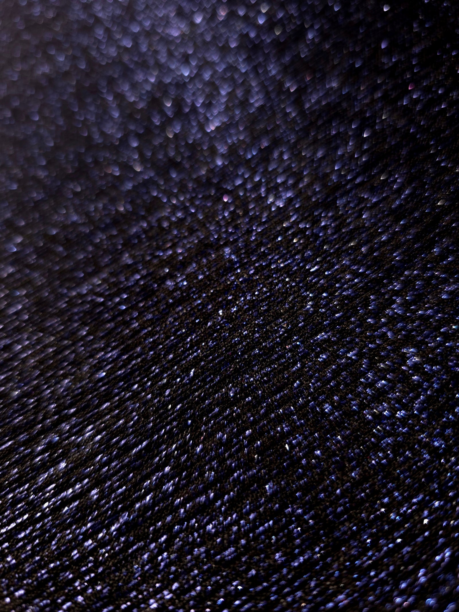 Close-up of Midnight Navy Sheer Glitter Stretch Tulle Fabric highlighting all-over glitter, fine mesh texture and airy transparency