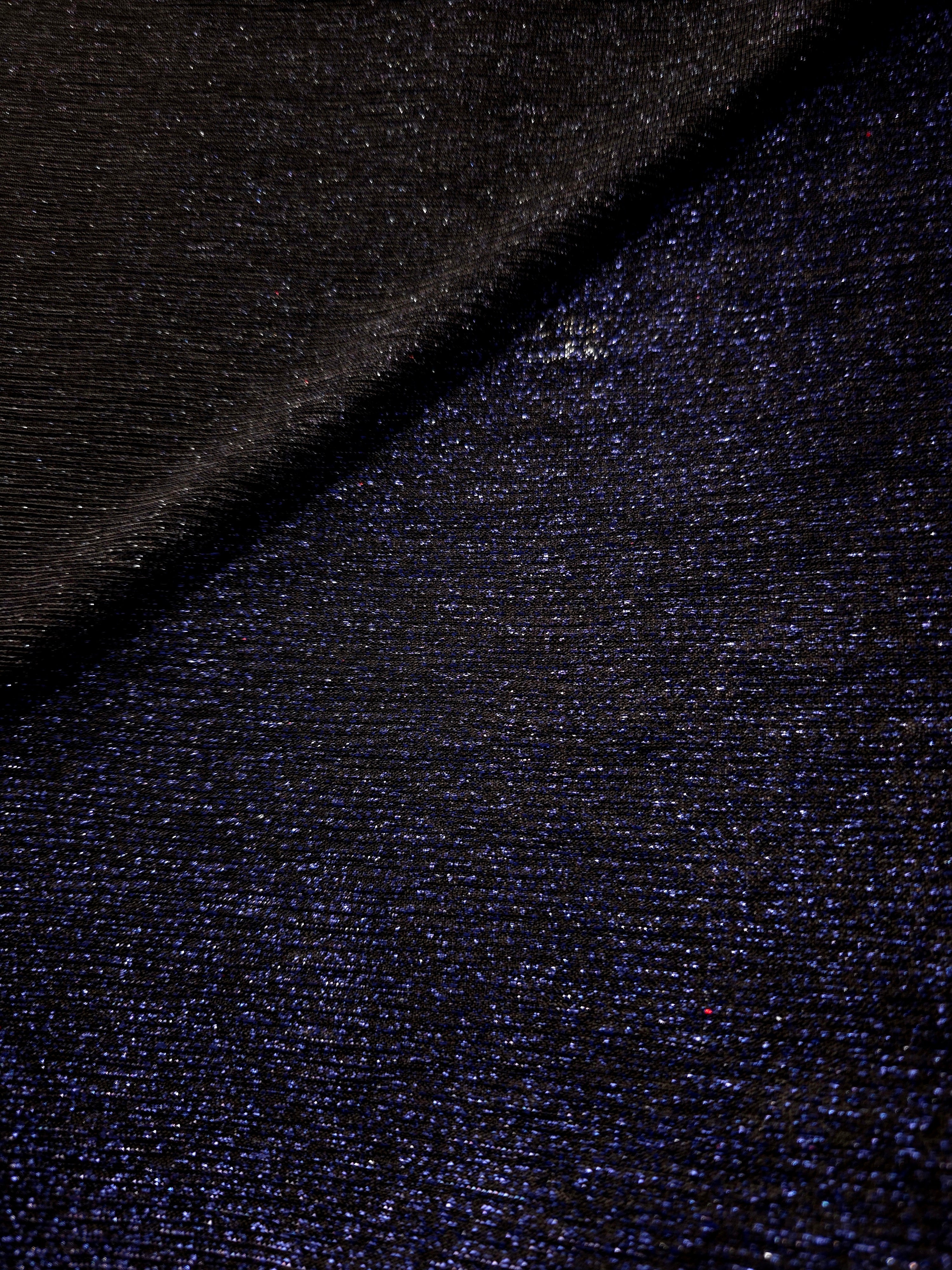 Front and back of Midnight Navy Sheer Glitter Stretch Tulle Fabric showing transparent knit construction and flexible 4-way stretch