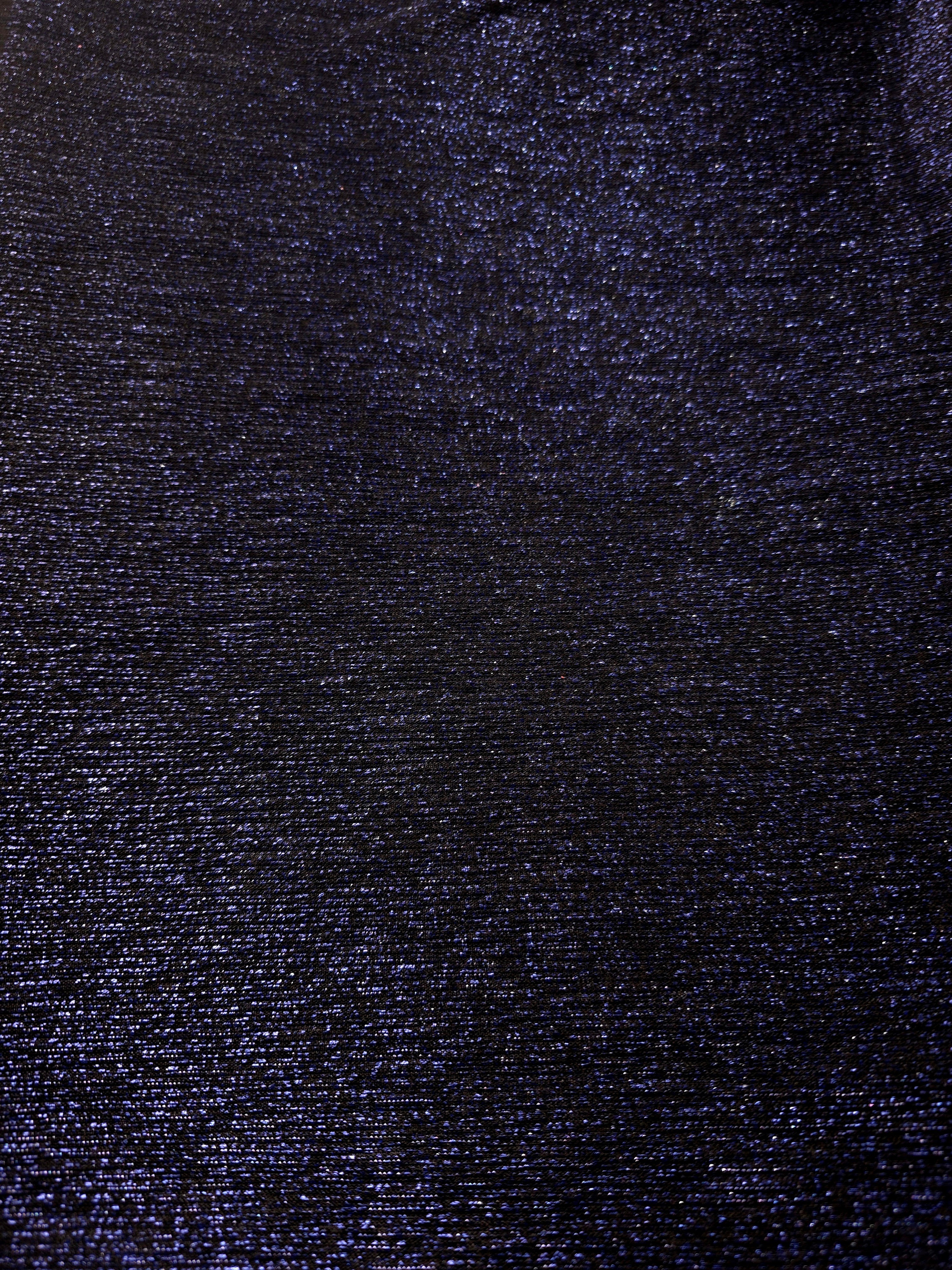 Surface detail of Midnight Navy Sheer Glitter Stretch Tulle Fabric showing glitter coverage across the fine sheer tulle base