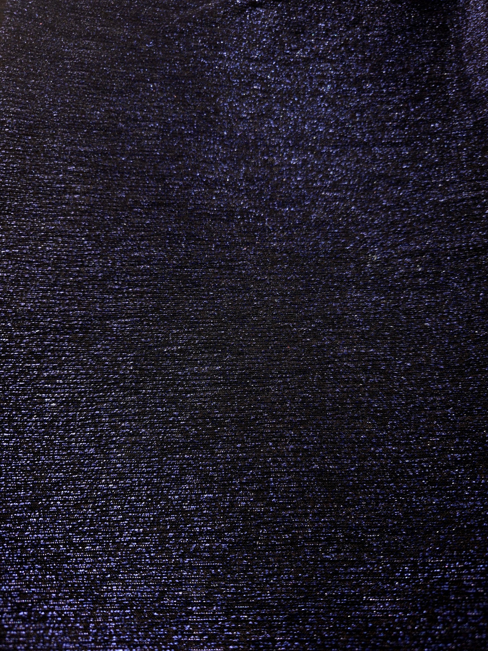 Surface detail of Midnight Navy Sheer Glitter Stretch Tulle Fabric showing glitter coverage across the fine sheer tulle base
