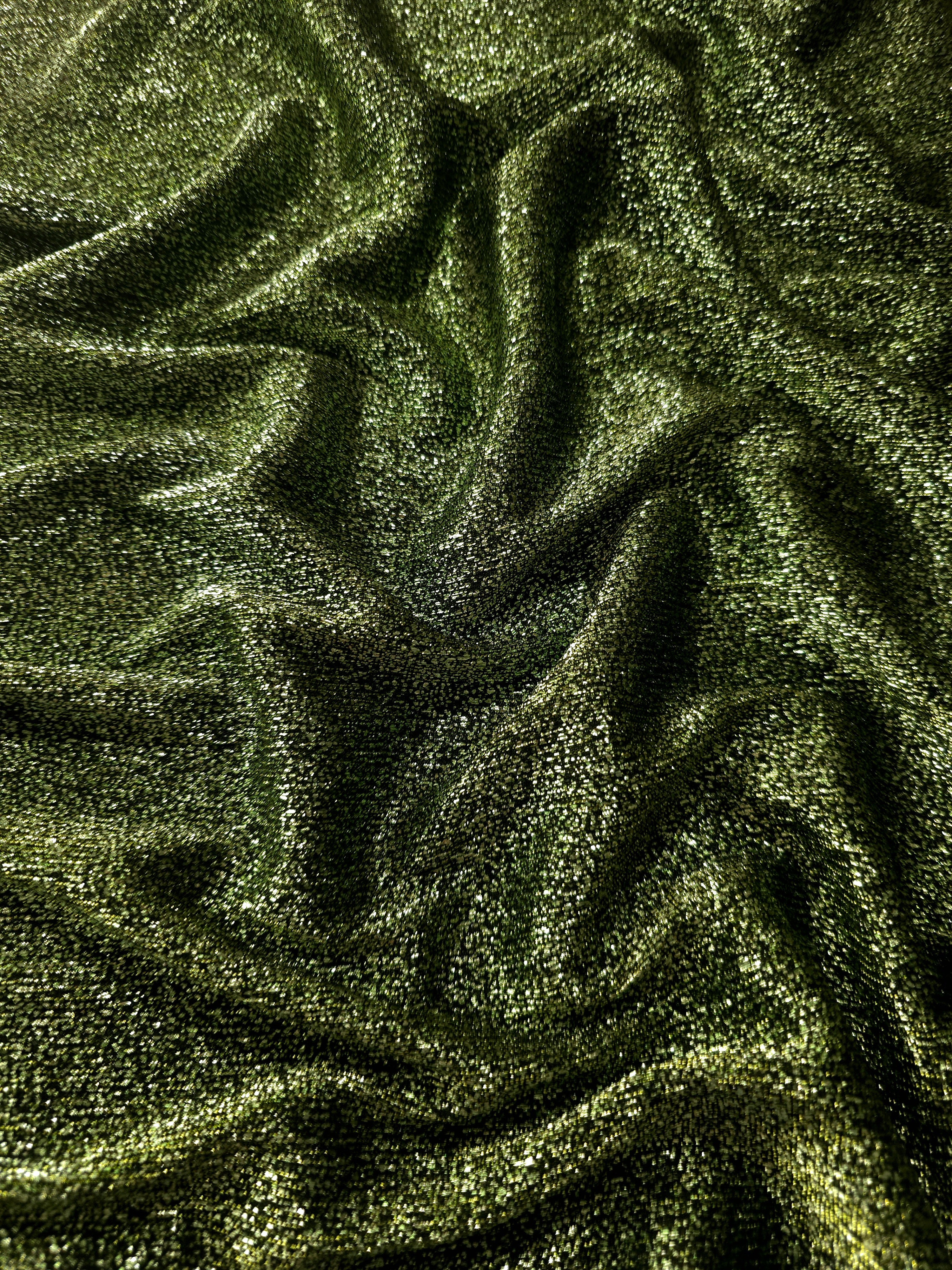 Front and back of Olive Green Sheer Glitter Stretch Tulle Fabric showing transparent knit construction and flexible 4-way stretch