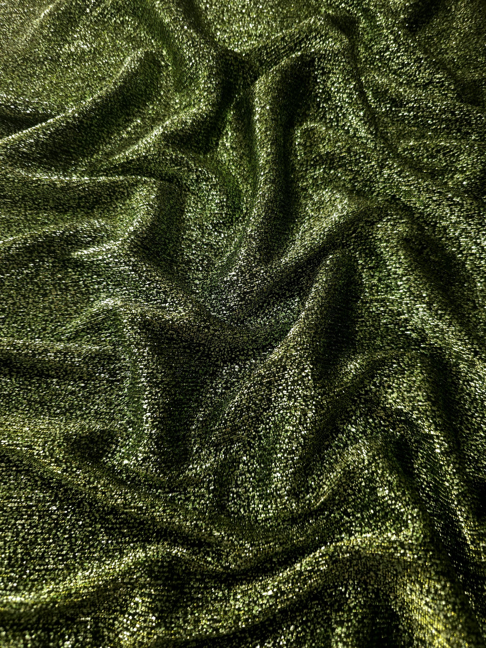 Front and back of Olive Green Sheer Glitter Stretch Tulle Fabric showing transparent knit construction and flexible 4-way stretch