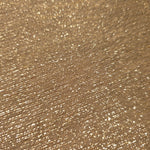Close-up of Pale Gold Sheer Glitter Stretch Tulle Fabric highlighting all-over glitter, fine mesh texture and airy transparency