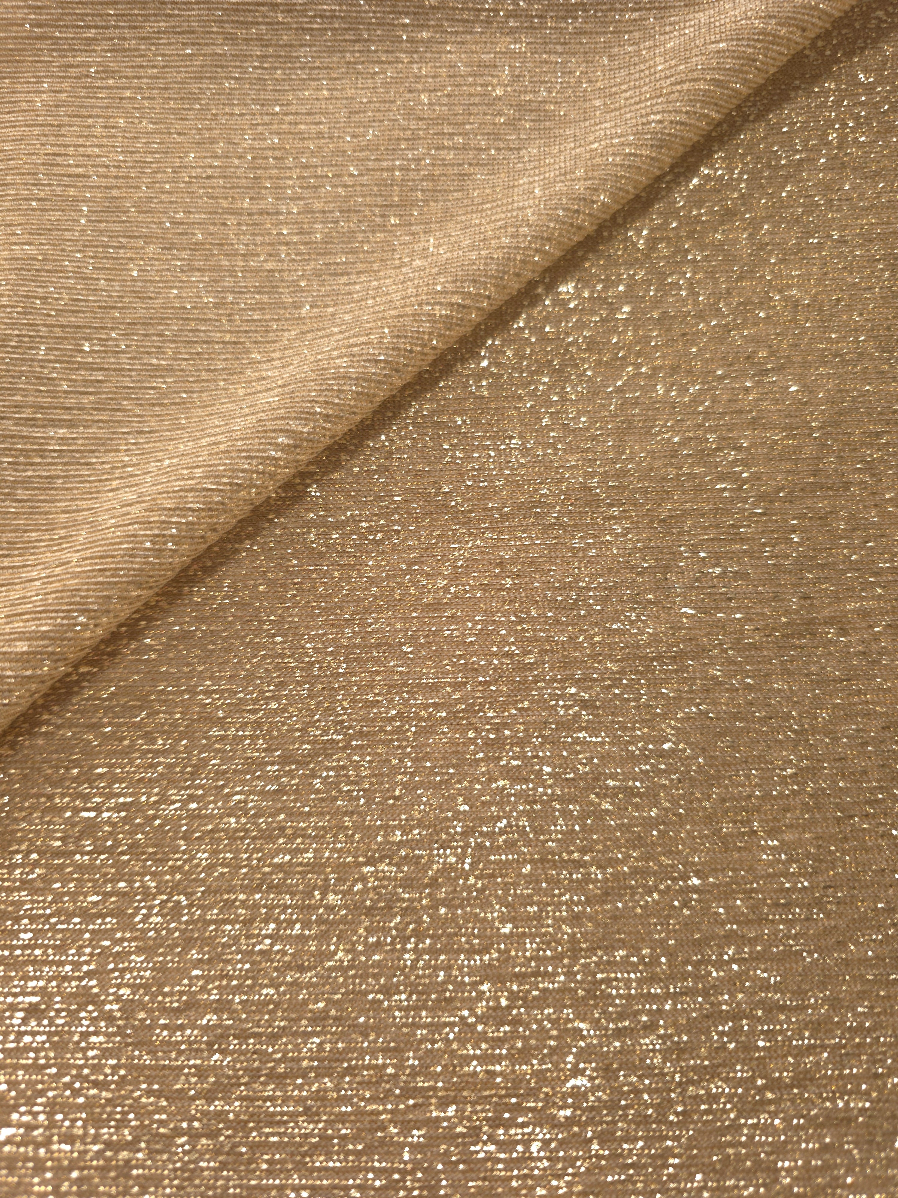 Front and back of Pale Gold Sheer Glitter Stretch Tulle Fabric showing transparent knit construction and flexible 4-way stretch