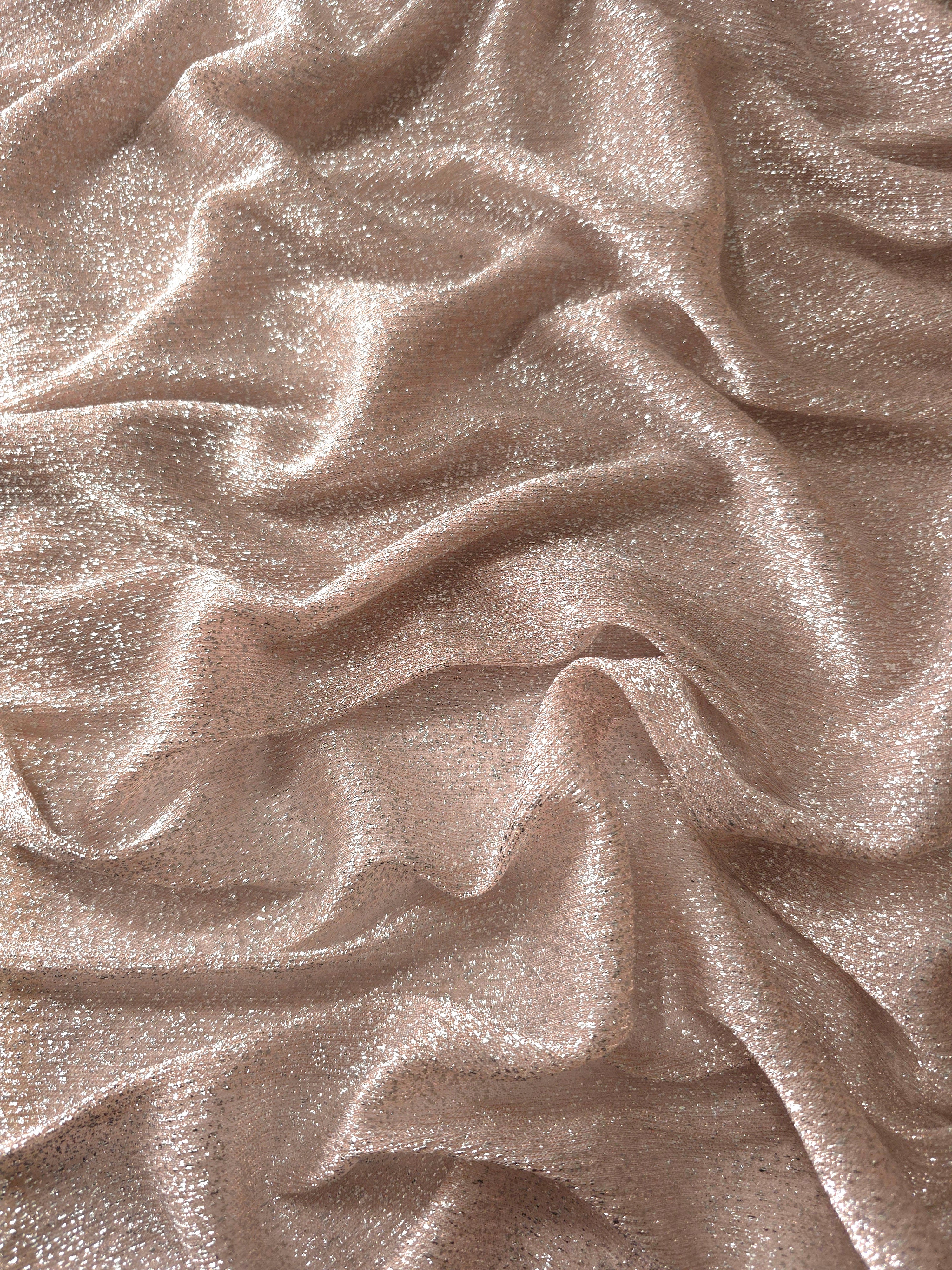 Draped Rose Taupe Sheer Glitter Stretch Tulle Fabric showing scattered sparkle across fluid folds for eveningwear and stage looks