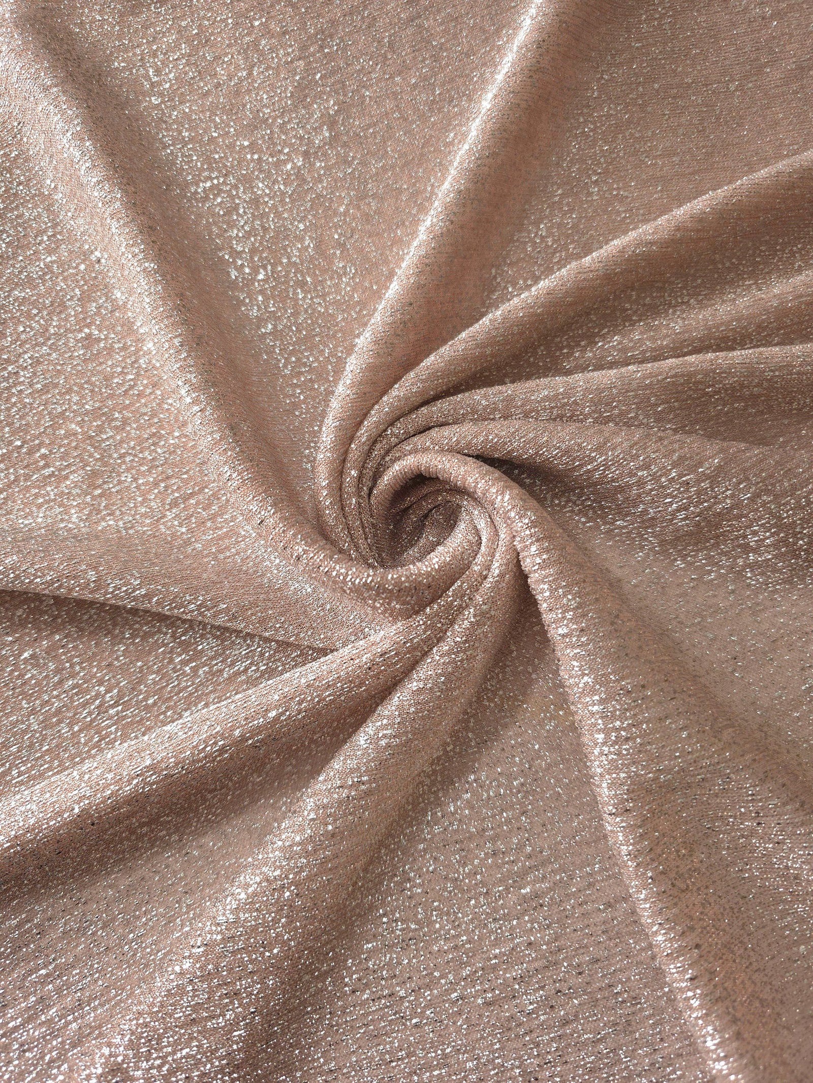 Swirl-draped Rose Taupe Sheer Glitter Stretch Tulle Fabric capturing reflective sparkle and fluid movement through flexible folds