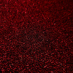 Close-up of Ruby Red Sheer Glitter Stretch Tulle Fabric highlighting all-over glitter, fine mesh texture and airy transparency