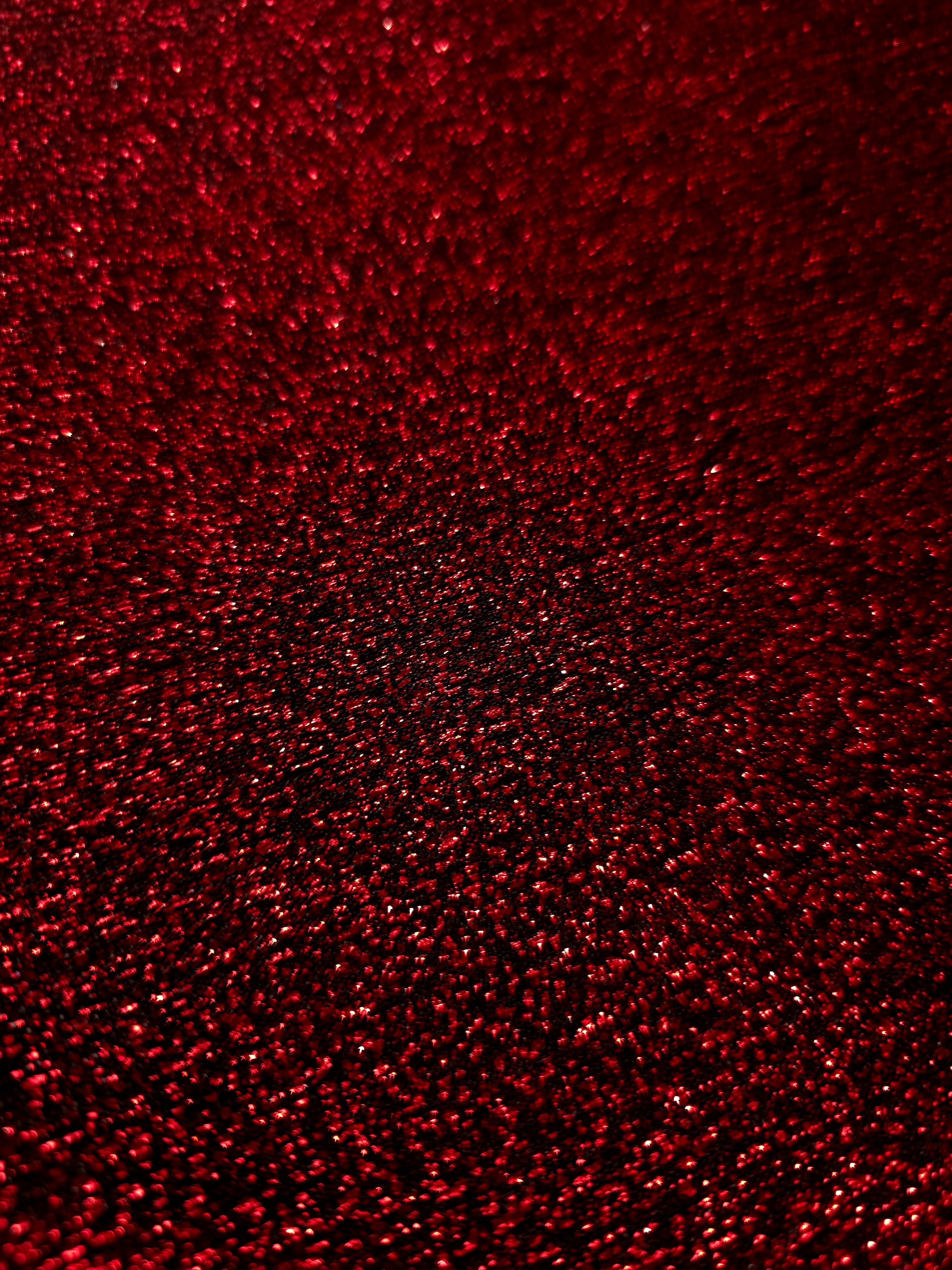 Close-up of Ruby Red Sheer Glitter Stretch Tulle Fabric highlighting all-over glitter, fine mesh texture and airy transparency