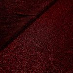 Front and back of Ruby Red Sheer Glitter Stretch Tulle Fabric showing transparent knit construction and flexible 4-way stretch