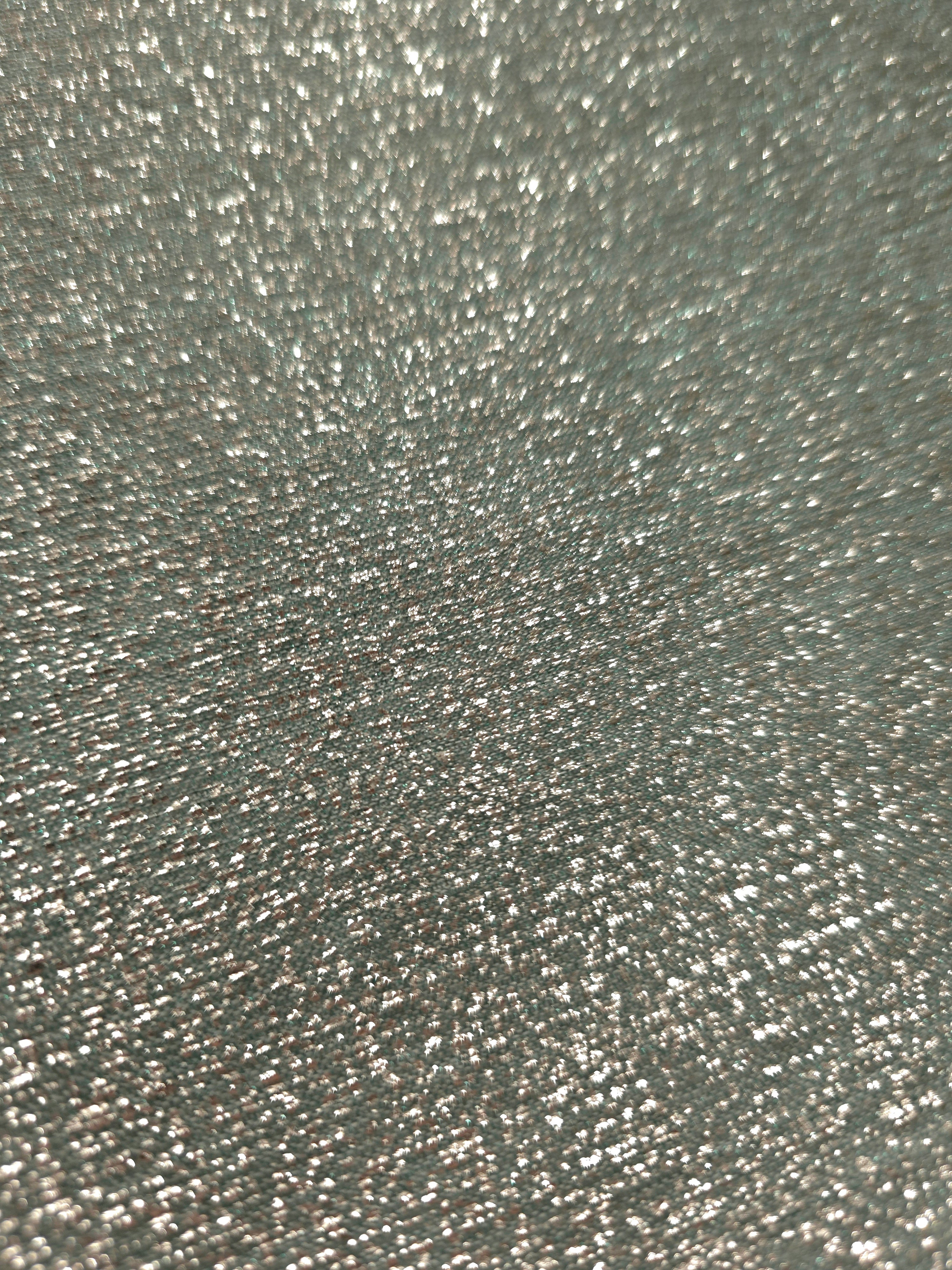 Close-up of Silver Sage Sheer Glitter Stretch Tulle Fabric highlighting all-over glitter, fine mesh texture and airy transparency