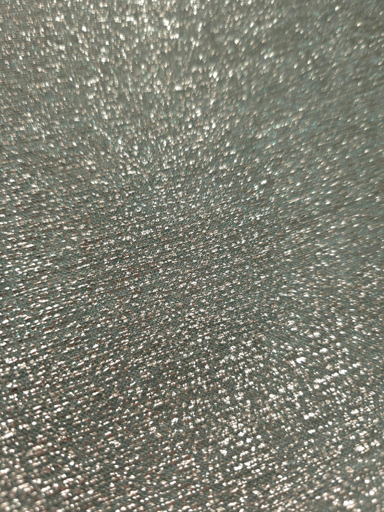 Close-up of Silver Sage Sheer Glitter Stretch Tulle Fabric highlighting all-over glitter, fine mesh texture and airy transparency