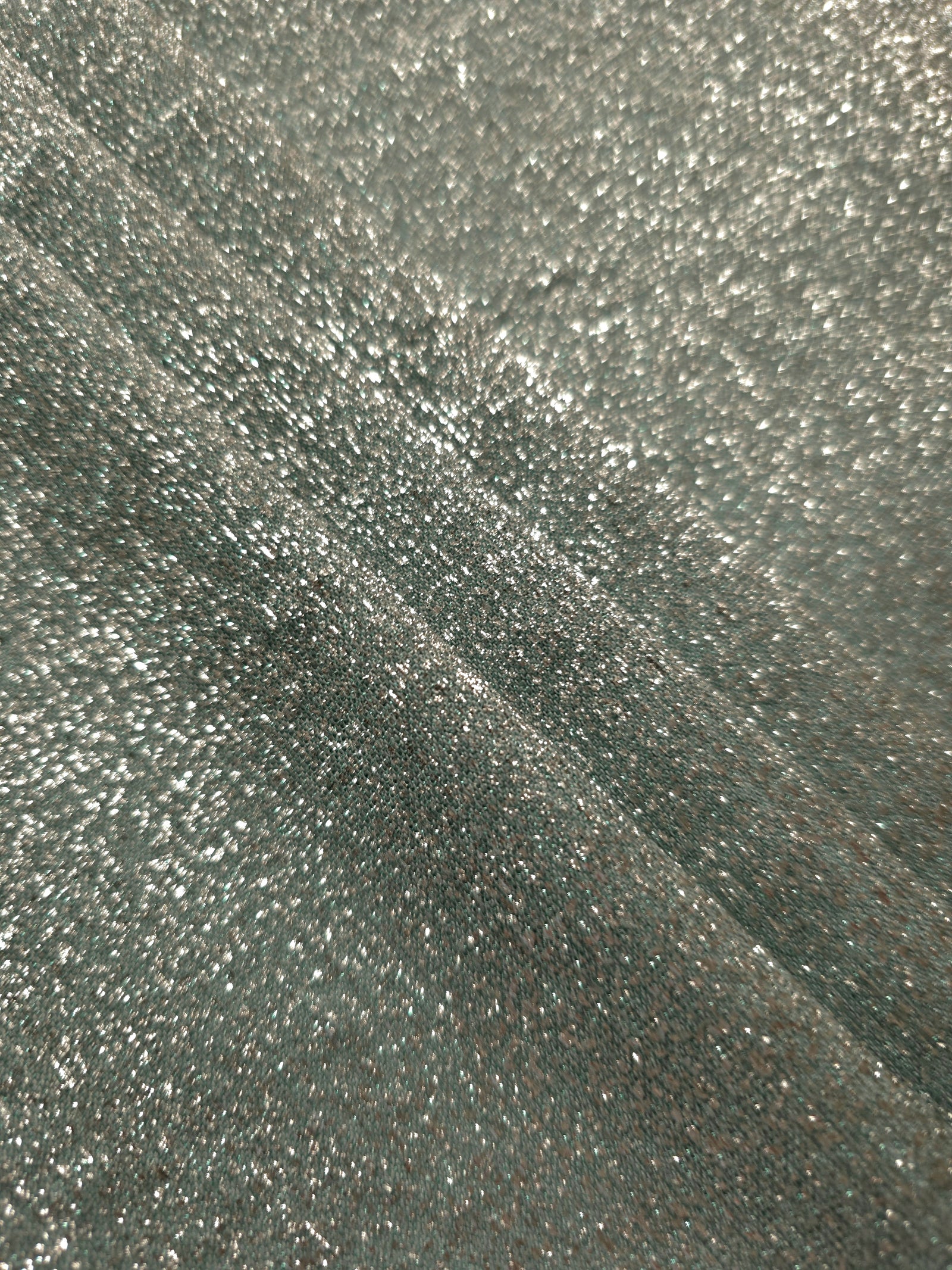 Layered Silver Sage Sheer Glitter Stretch Tulle Fabric showing richer sparkle, soft depth and lightweight transparent folds