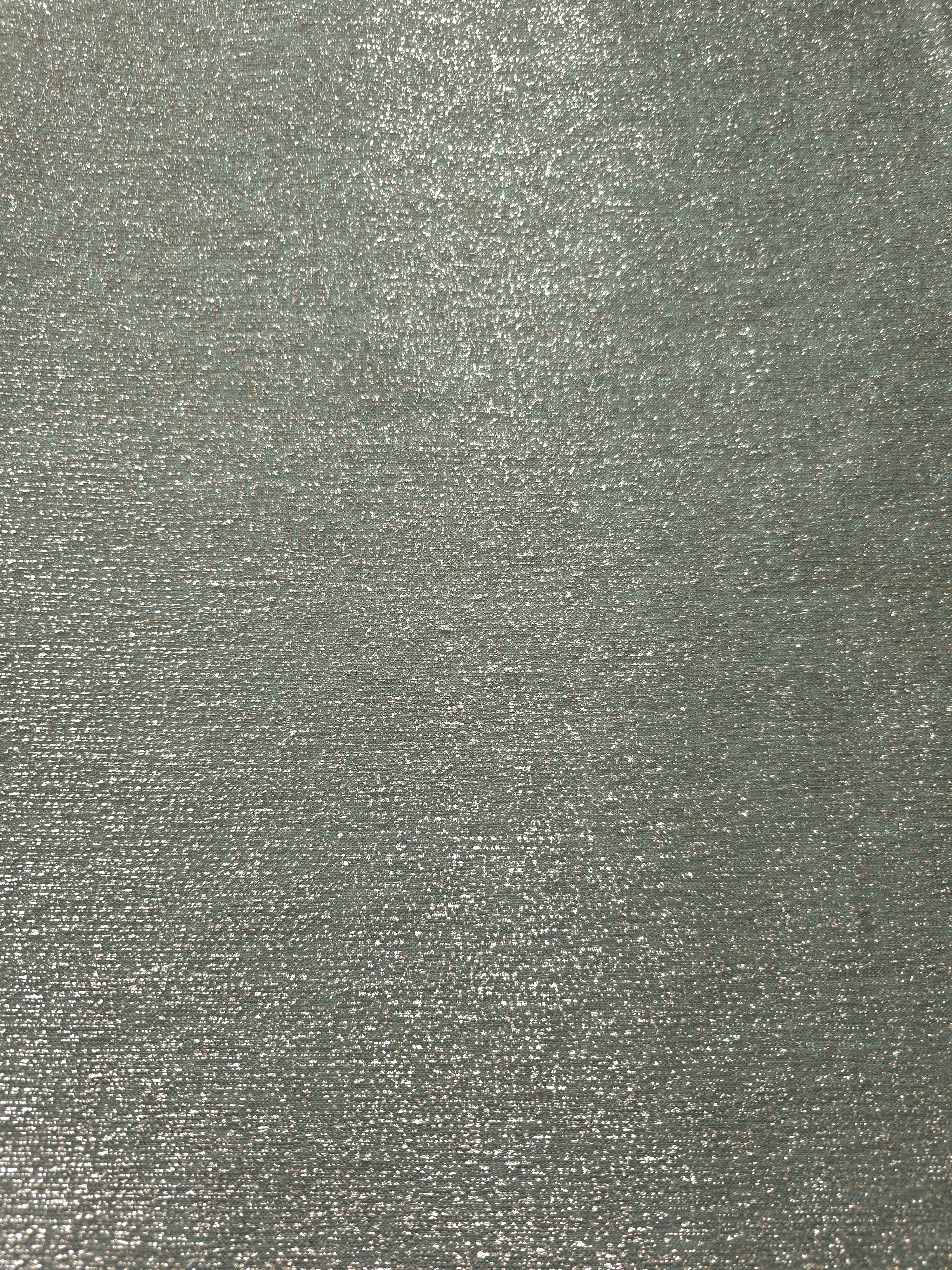 Surface detail of Silver Sage Sheer Glitter Stretch Tulle Fabric showing glitter coverage across the fine sheer tulle base