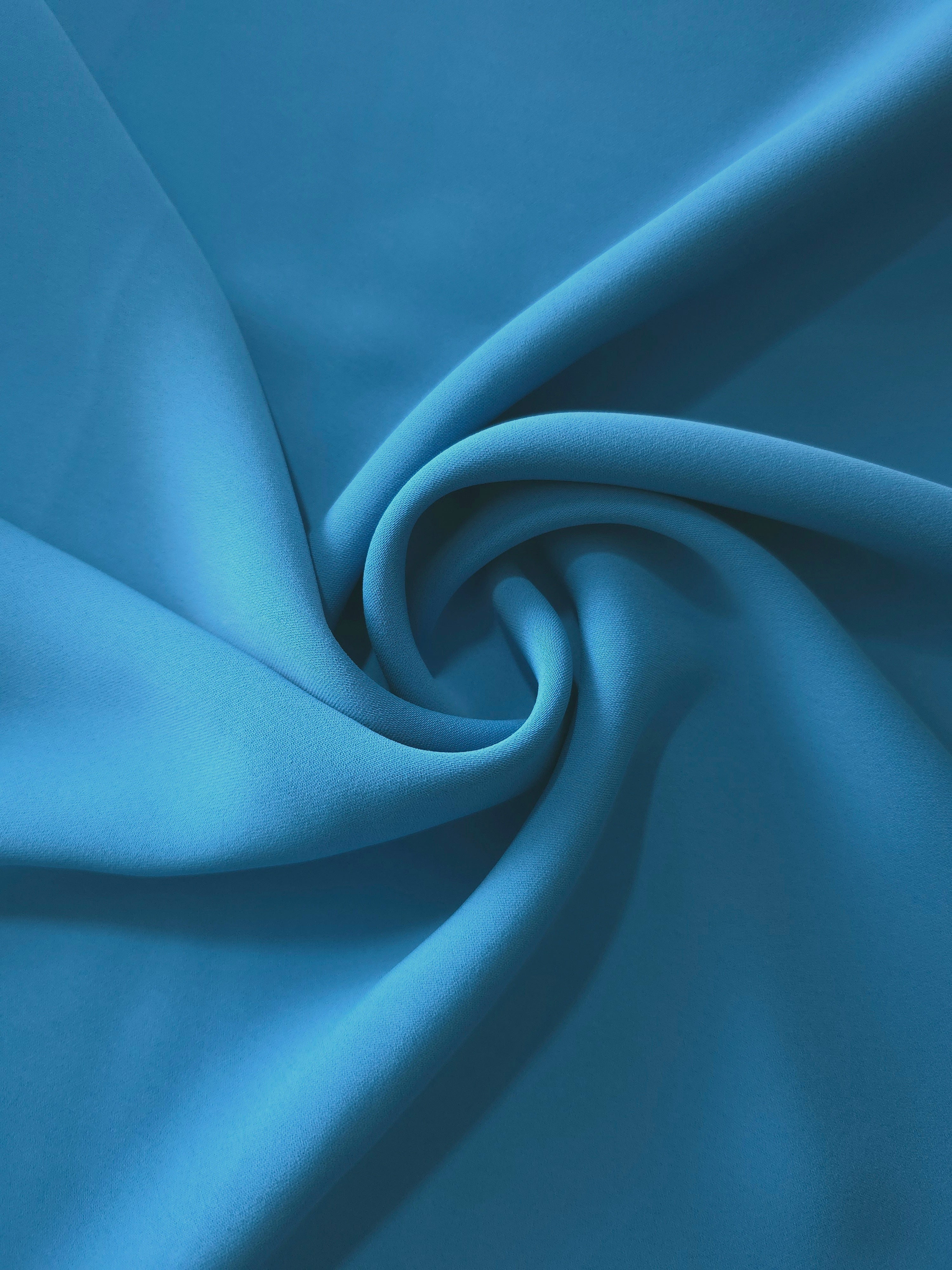 Steel Blue polyester crepe in a circular drape, showing graceful movement for occasionwear and modest fashion