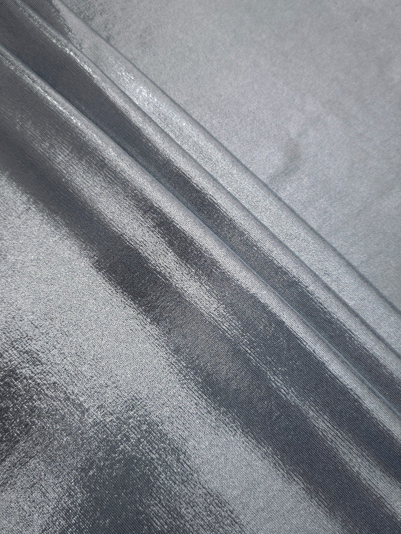 Steel Gray foiled spandex arranged in layered folds, displaying shimmer and soft structure for skirts, tops and performancewear