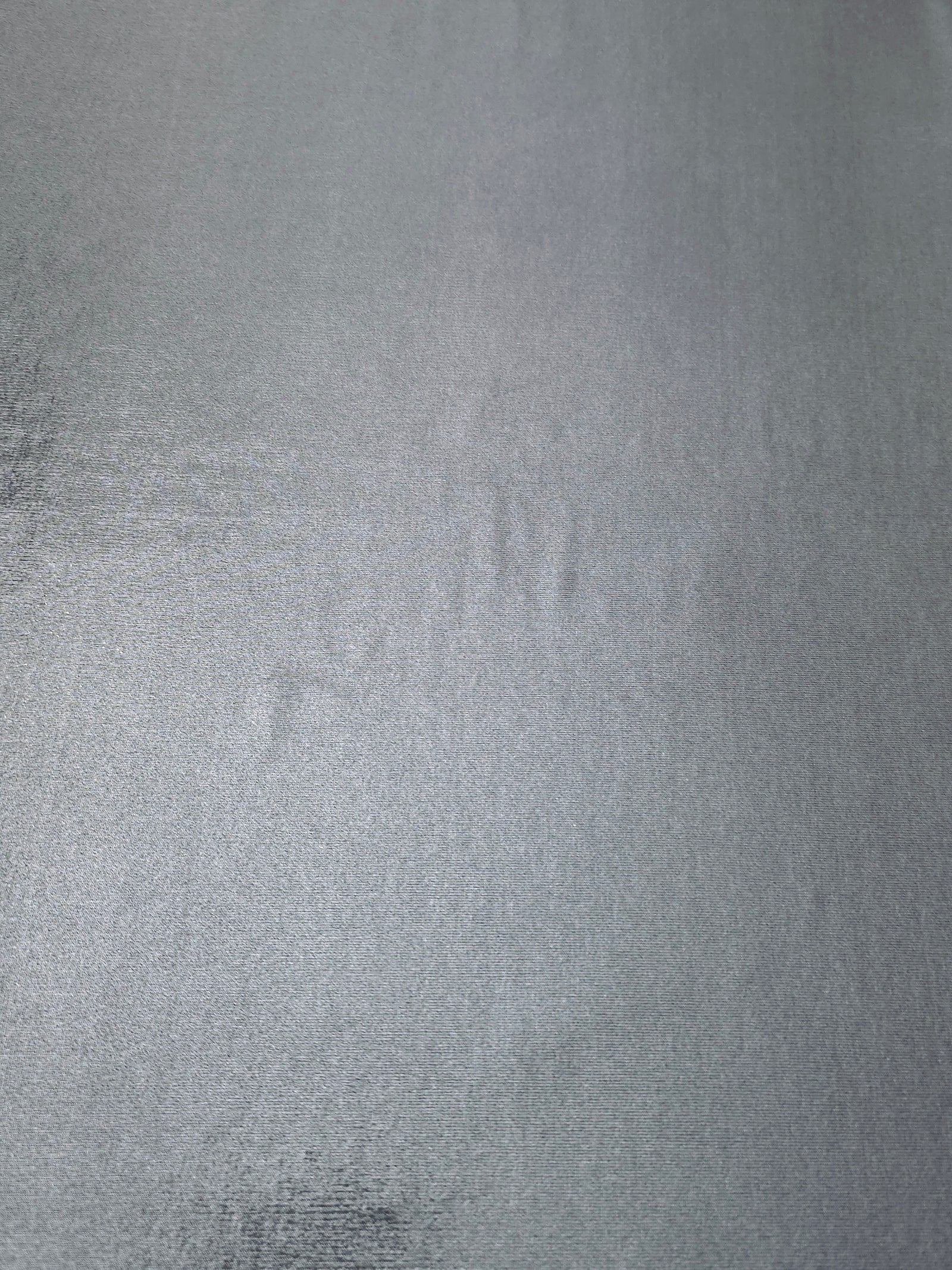Flat Steel Gray foiled stretch fabric with bright metallic reflection, ideal for performancewear, evening pieces and creative sewing