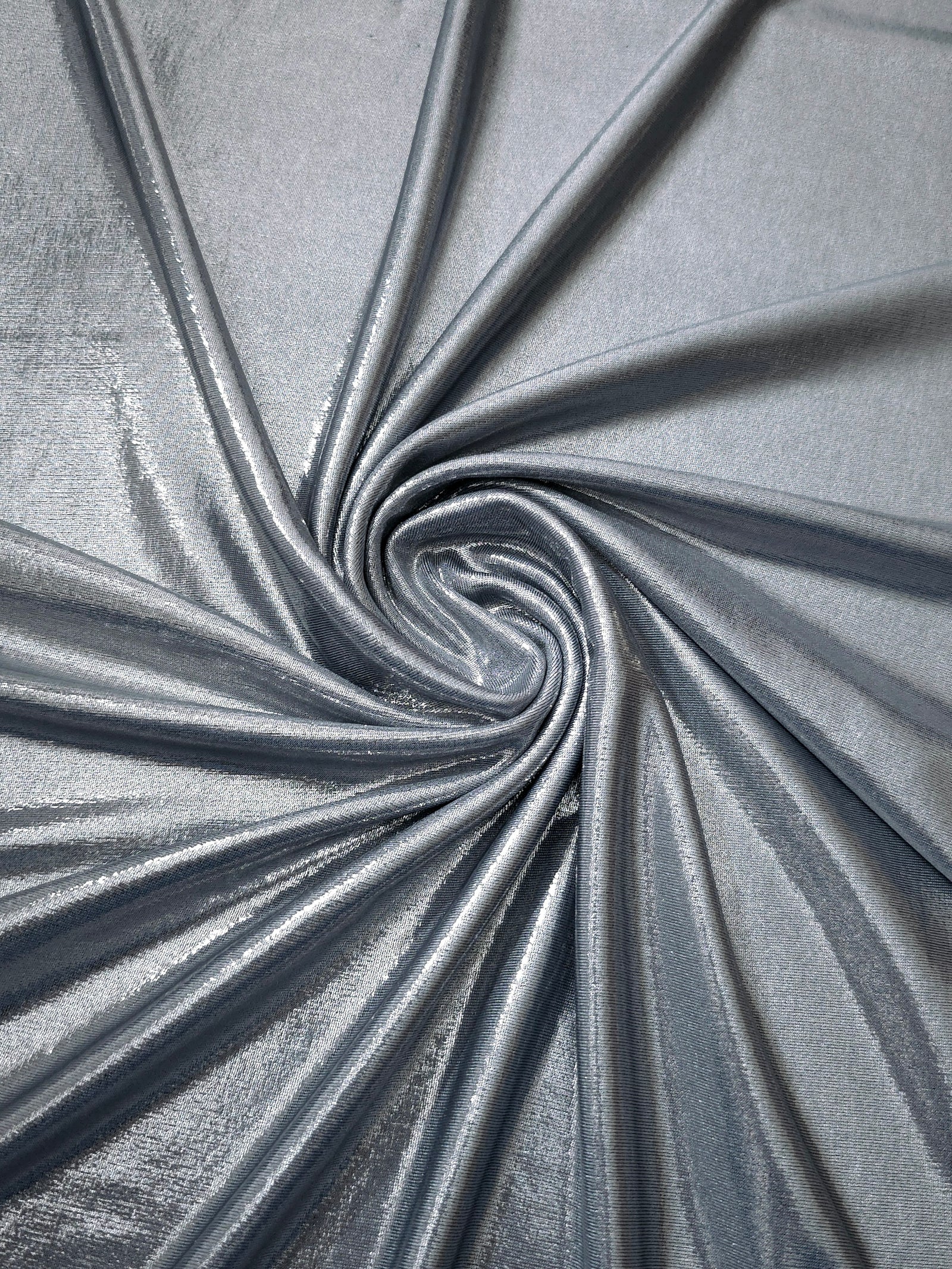 Flowing swirl of Steel Gray metallic stretch fabric, showing dynamic foil reflection for stagewear, skirts and creative fashion