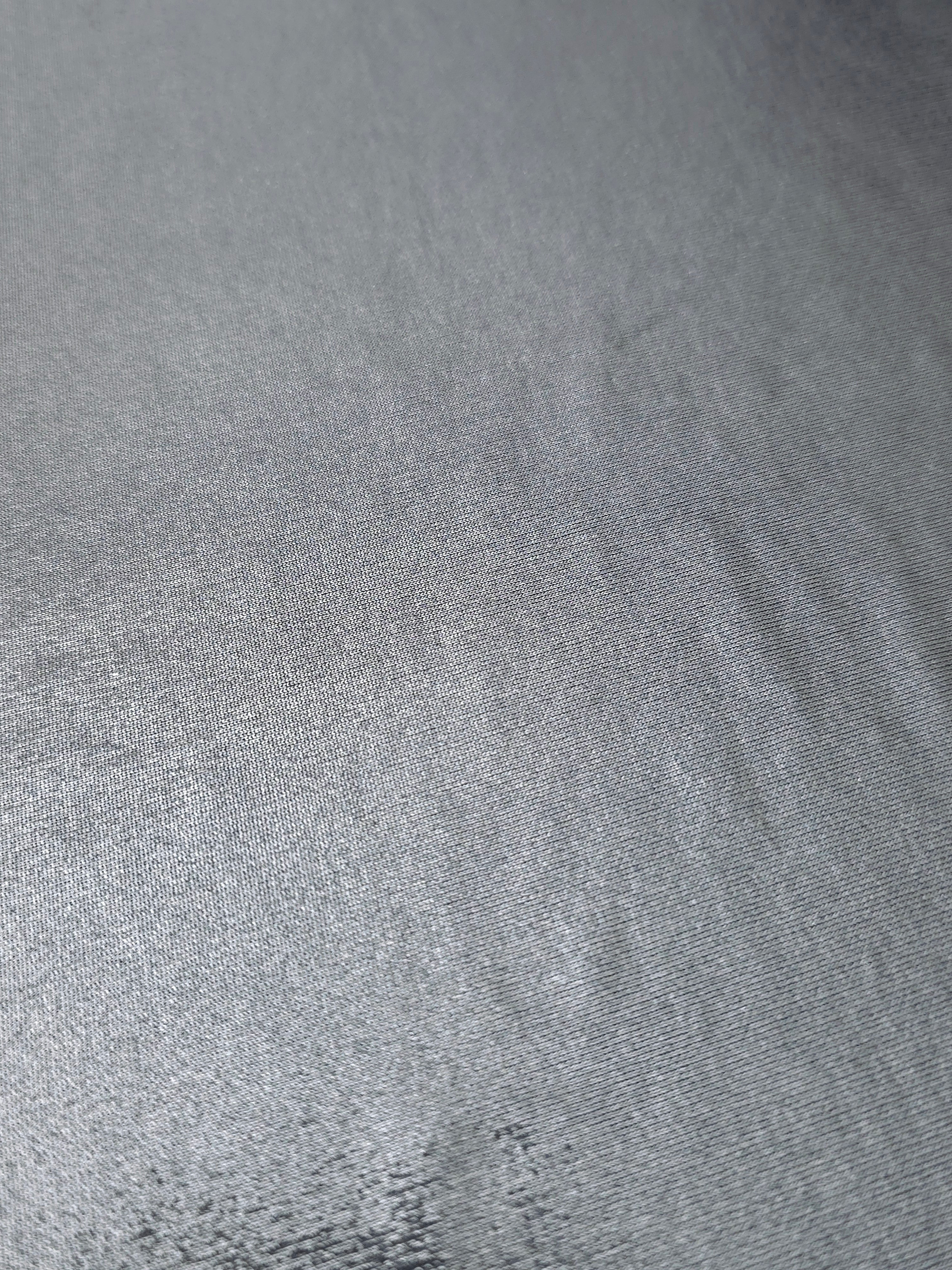 Steel Gray foiled stretch fabric texture close-up, displaying metallic reflection and fine surface character for apparel design