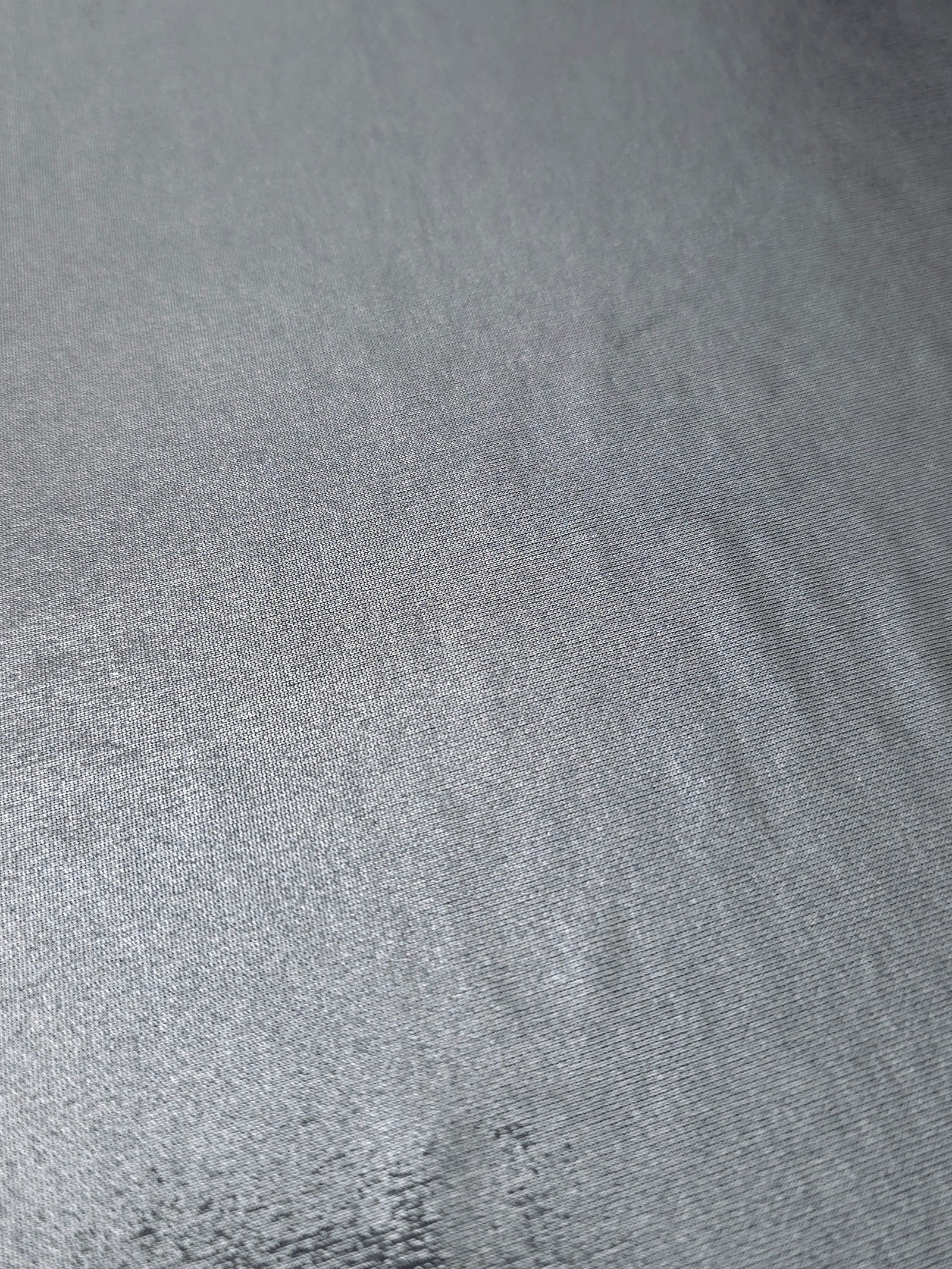 Steel Gray foiled stretch fabric texture close-up, displaying metallic reflection and fine surface character for apparel design