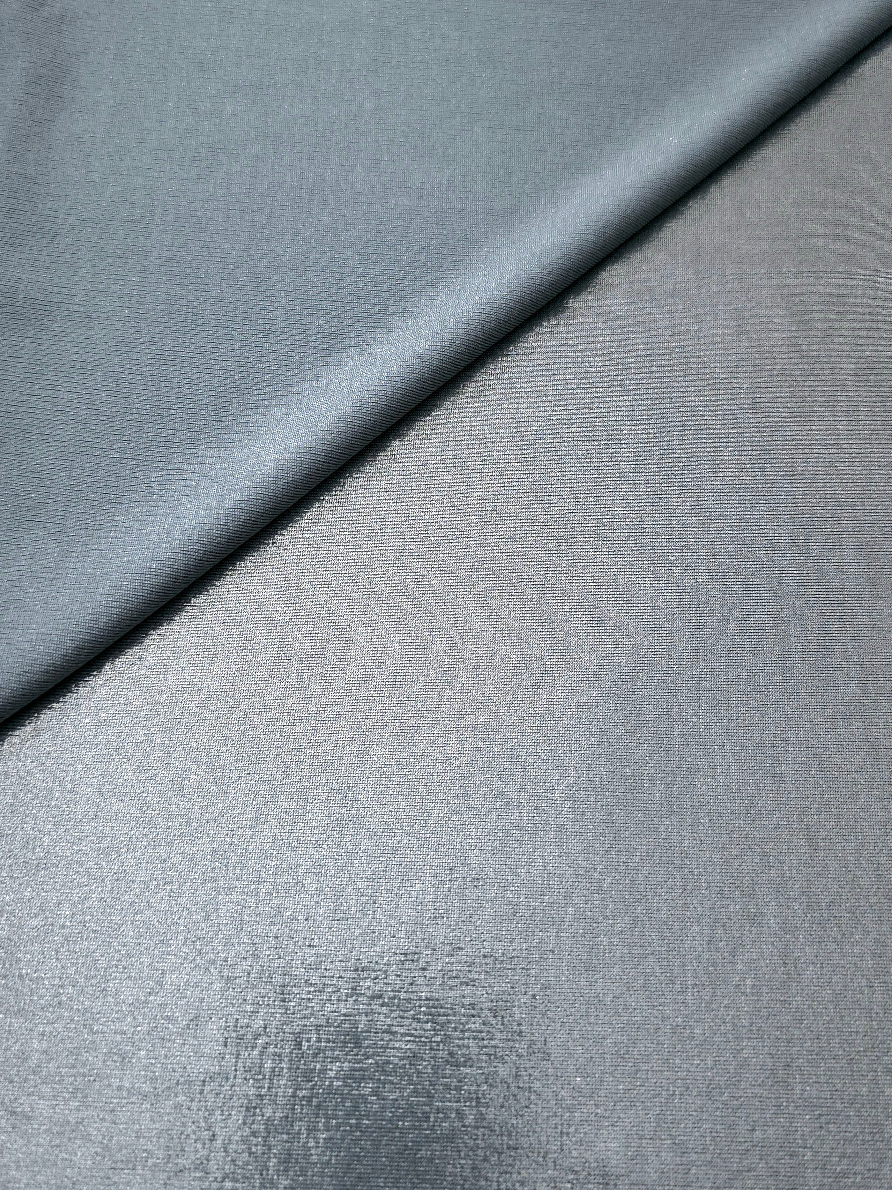 Softly folded Steel Gray foiled spandex showing metallic shine and flexible hand for costumes, eveningwear and creative sewing