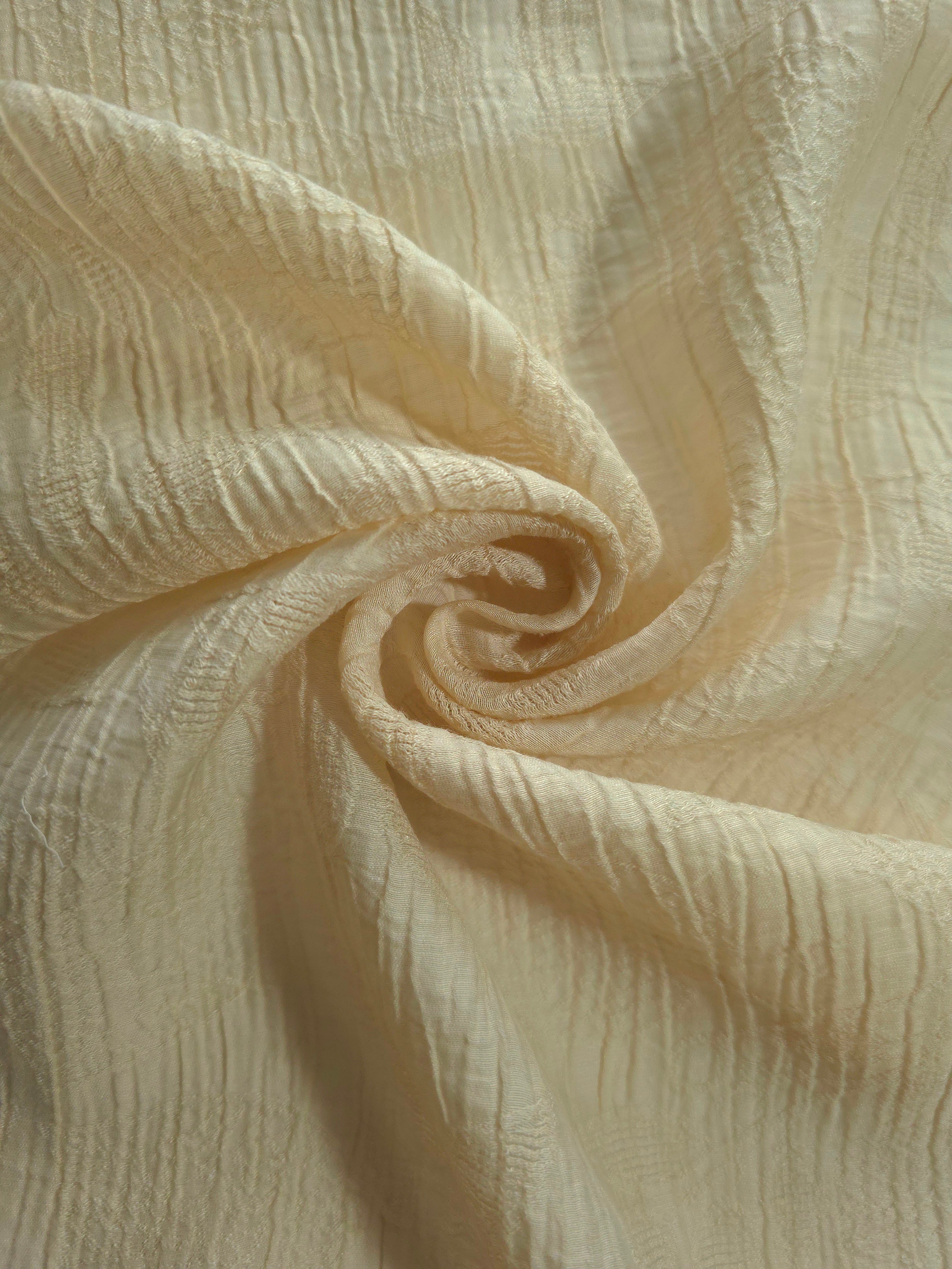 Folded Butter Yellow Tencel jacquard with tonal leaf texture for blouse and skirt layers.