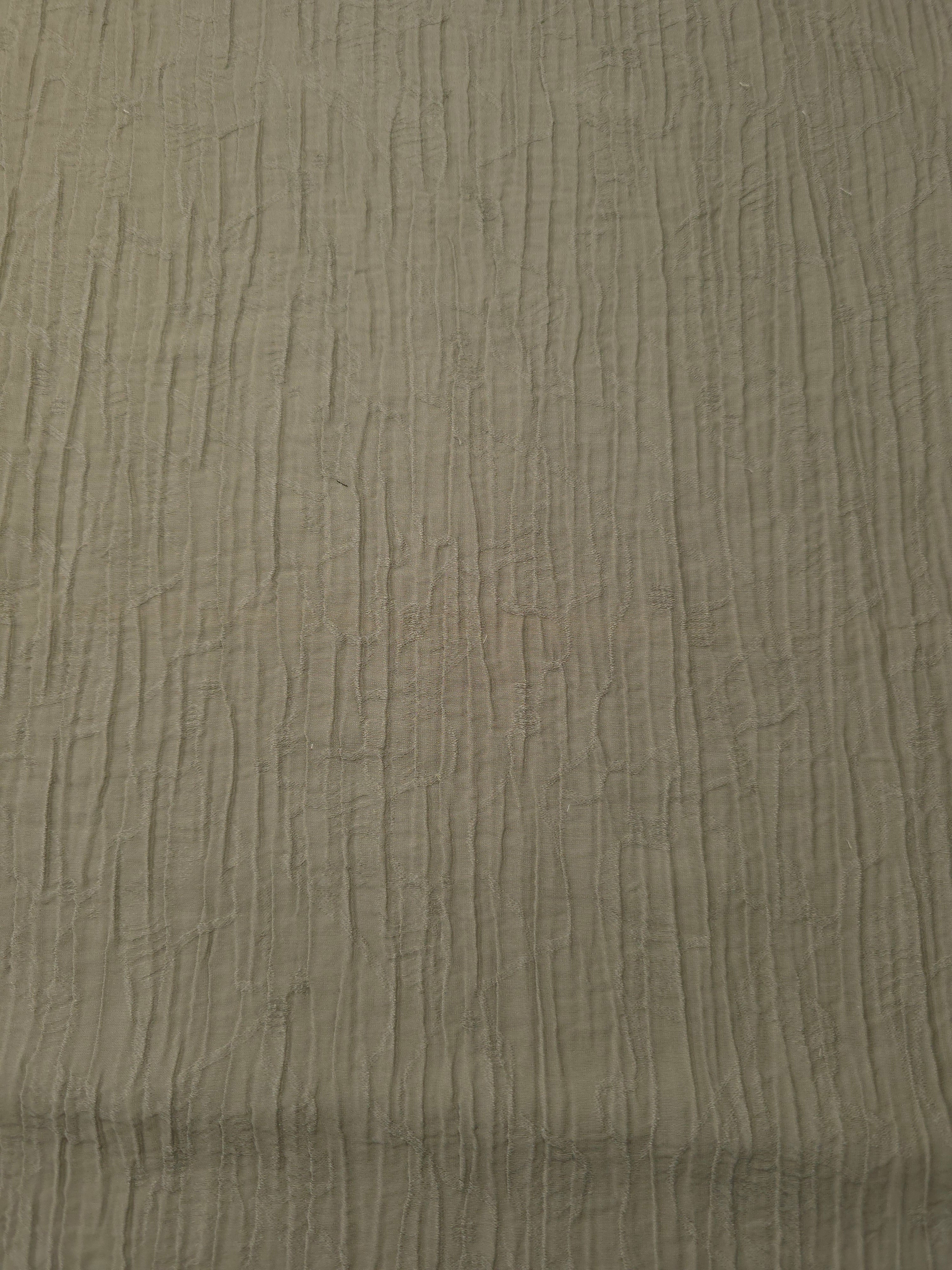 Flat view of Sage Green Tencel jacquard with fine root line texture for dresses and layers.