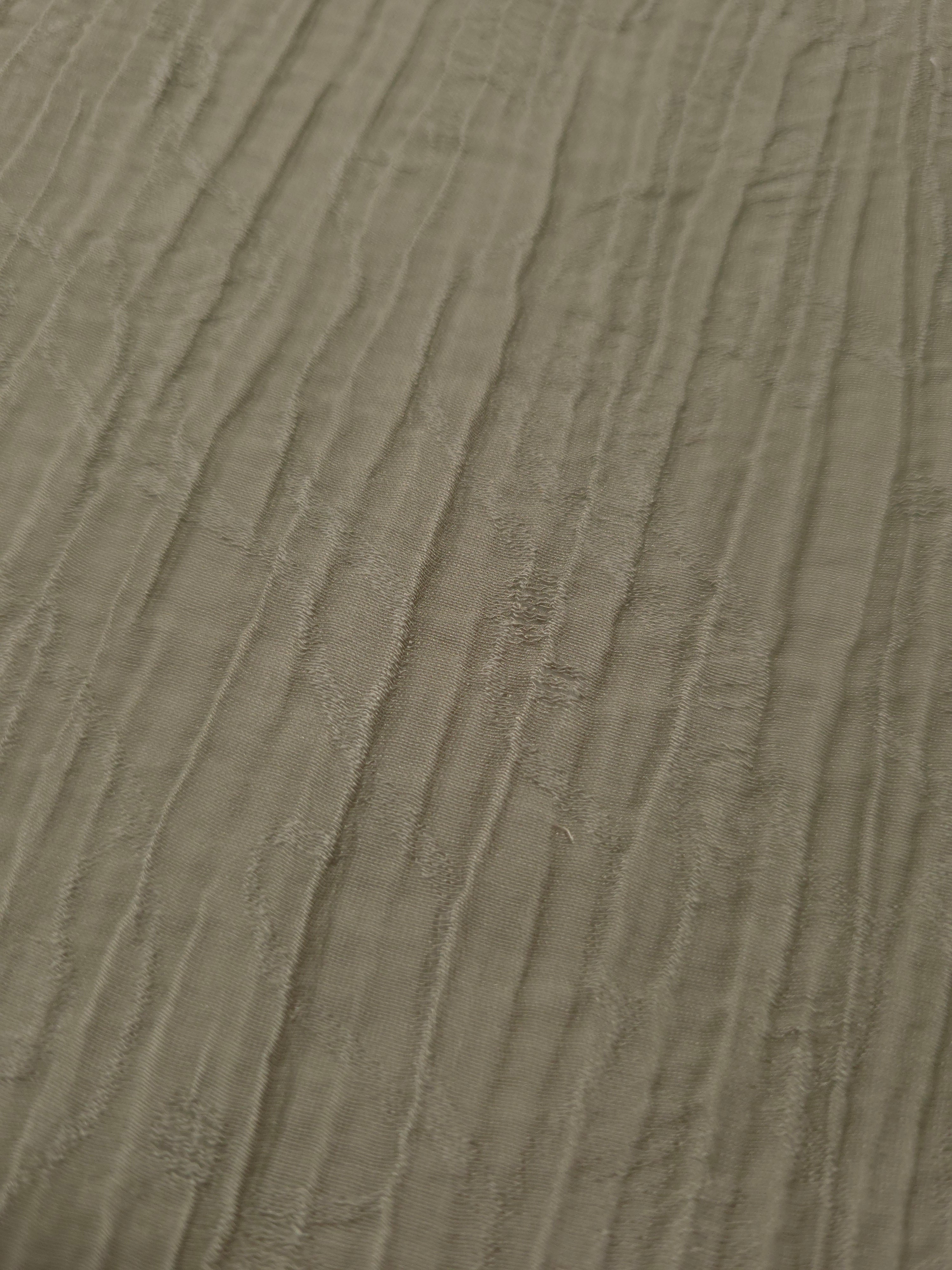 Close-up of Sage Green Tencel jacquard showing fine root line texture and light weave.