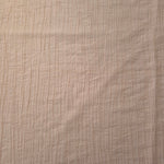 Flat view of Soft Beige Tencel jacquard with tonal leaf texture for dresses and layers.