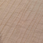 Detail view of Soft Beige Tencel jacquard with tonal leaf texture for soft layers.