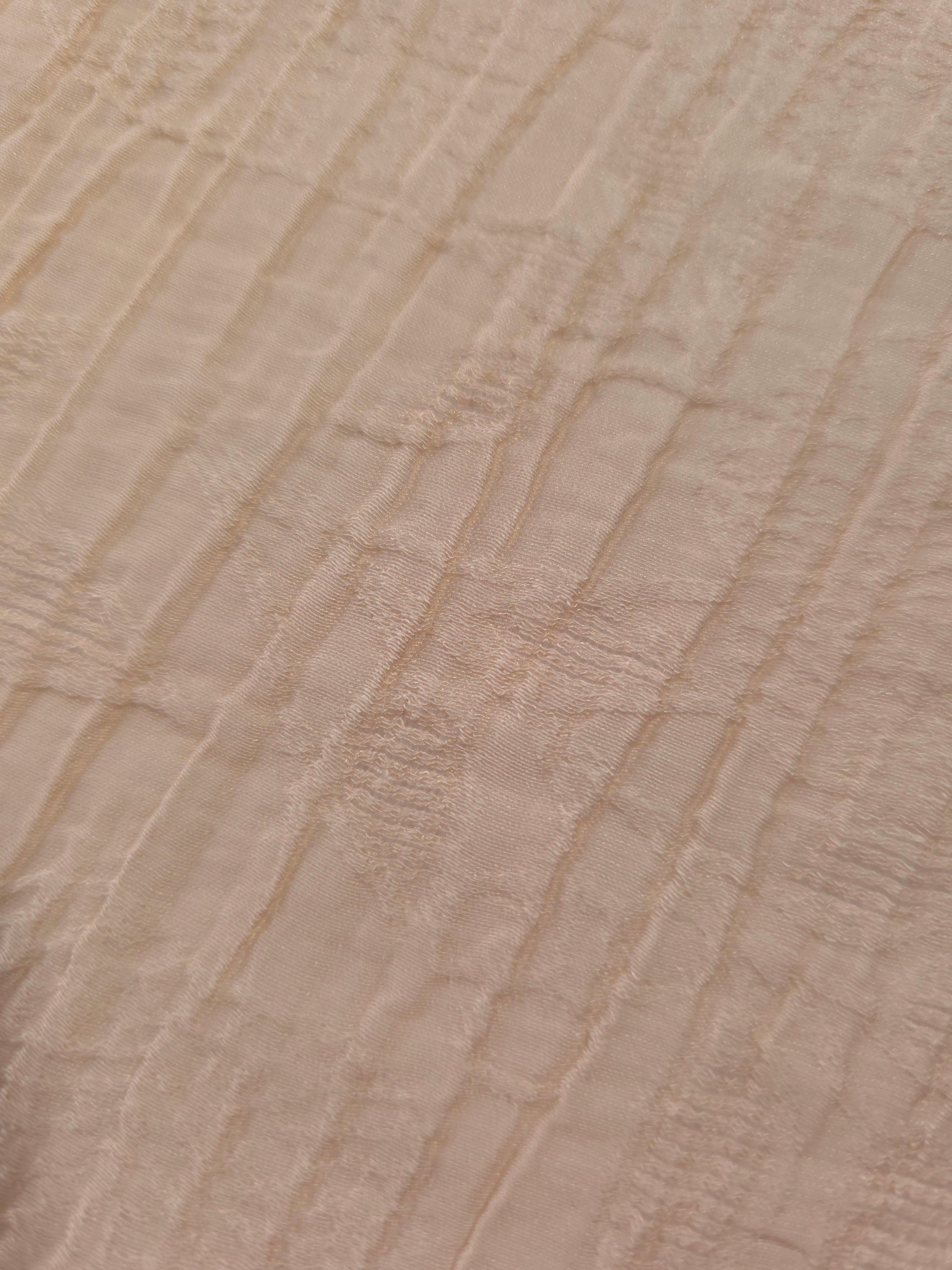 Detail view of Soft Beige Tencel jacquard with tonal leaf texture for soft layers.