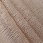 Folded Soft Beige Tencel jacquard with tonal leaf texture for blouse and skirt layers.