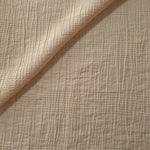 Draped Soft Beige Tencel jacquard showing airy movement for kaftans and dresses.