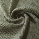Folded Sage Green Tencel jacquard with tonal stripe texture for blouse and skirt layers.
