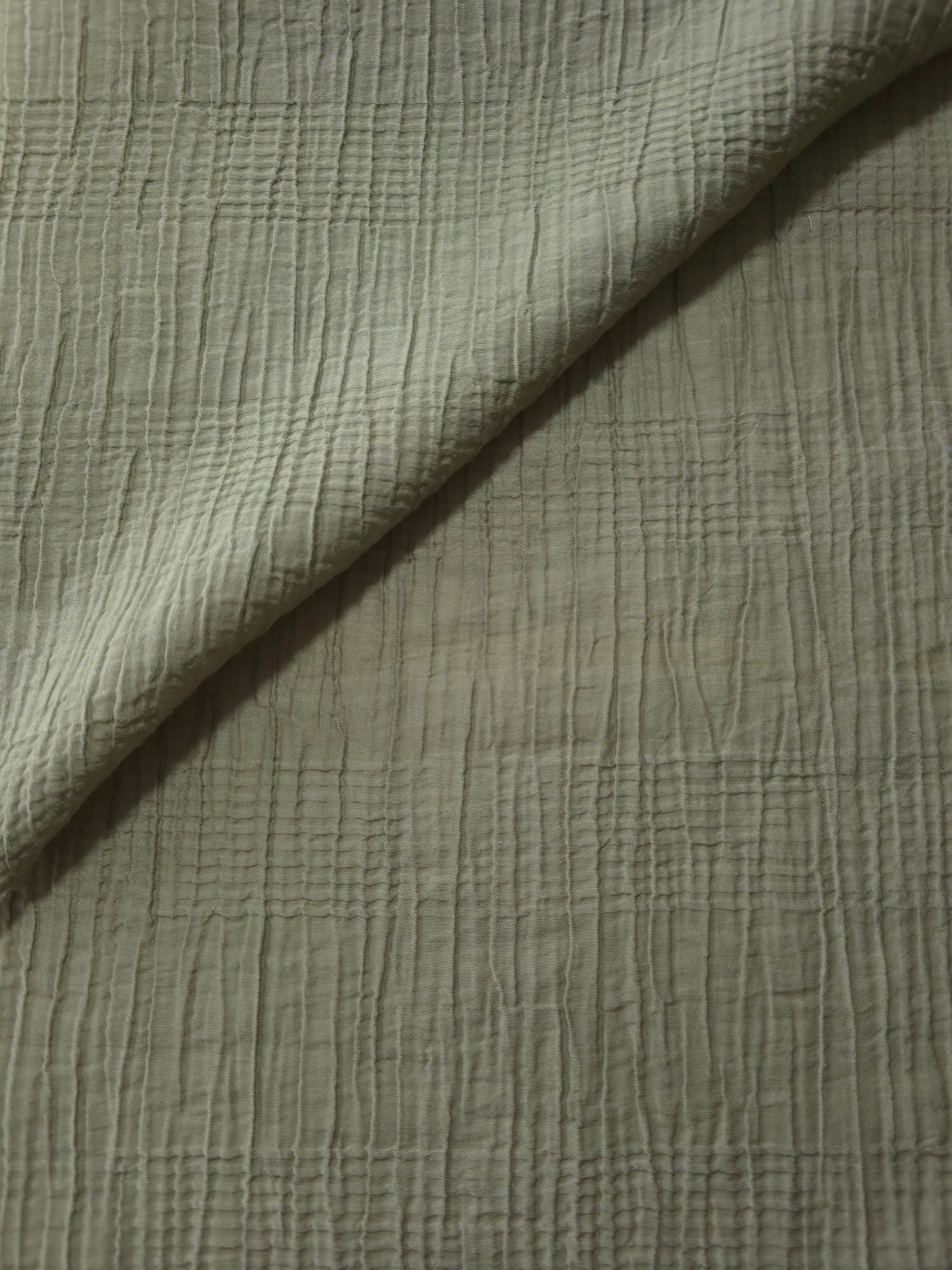 Draped Sage Green Tencel jacquard showing airy movement for kaftans and dresses.