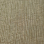 Detail view of Butter Yellow Tencel jacquard with tonal leaf texture for soft layers.