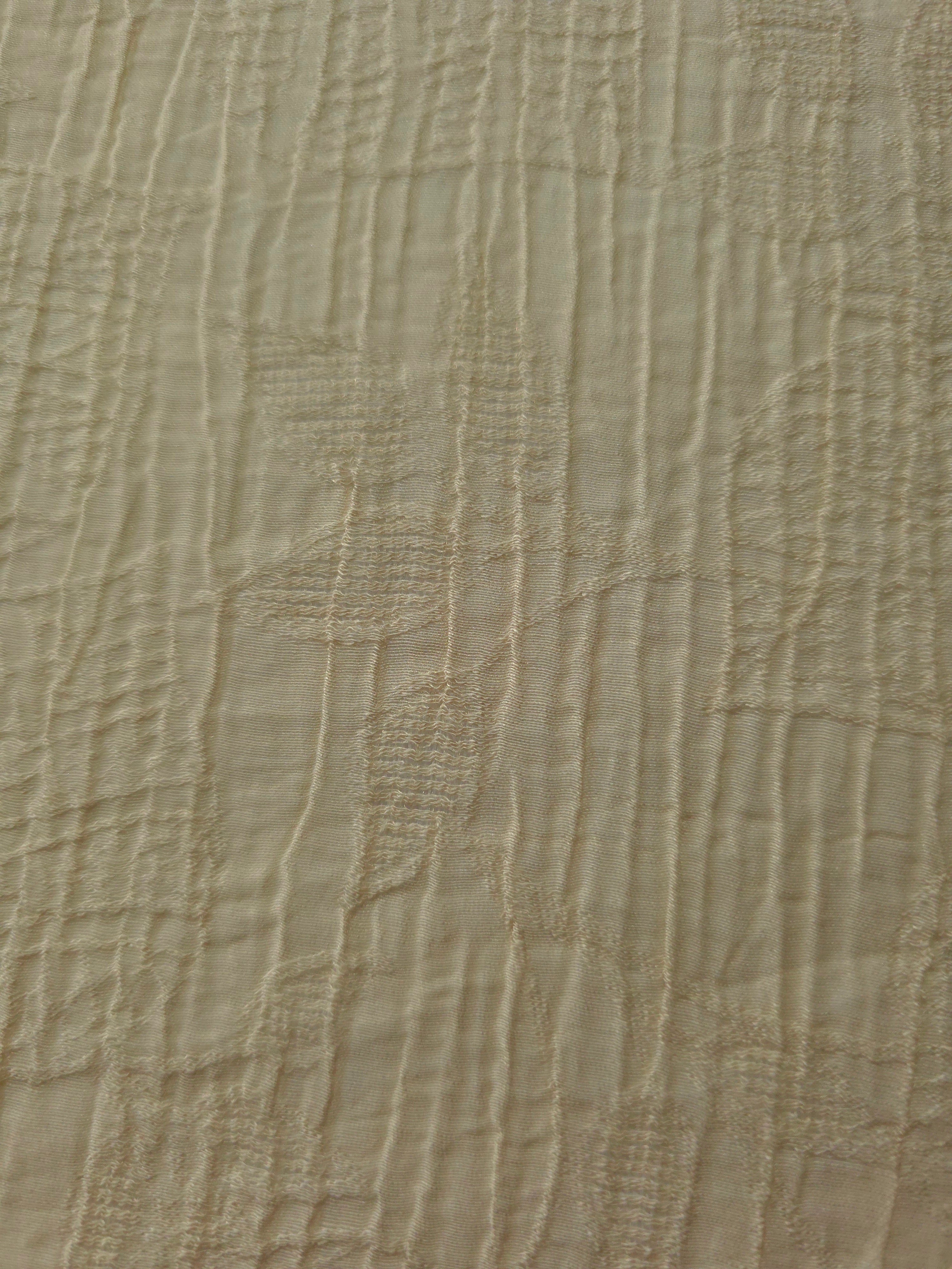 Detail view of Butter Yellow Tencel jacquard with tonal leaf texture for soft layers.