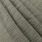 Folded Sage Green Tencel jacquard with tonal leaf texture for blouse and skirt layers.