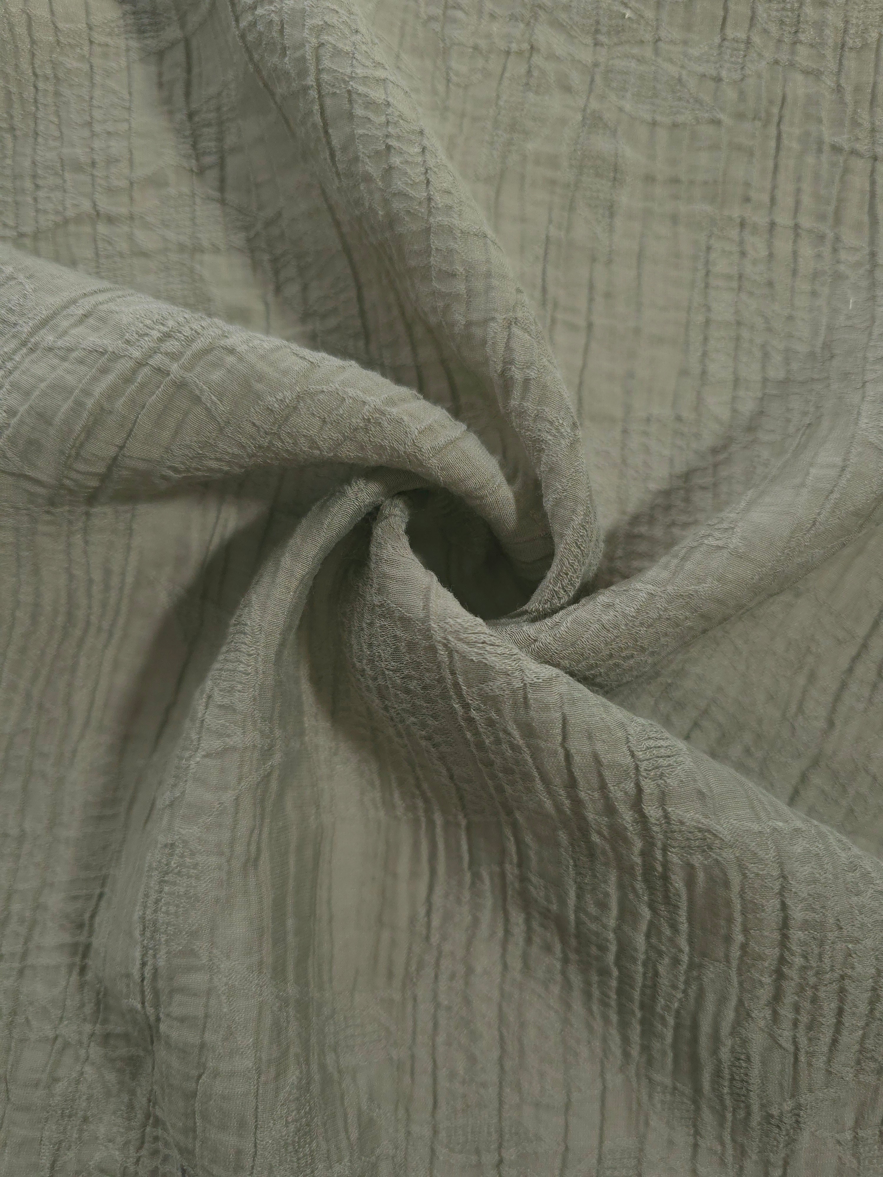 Flowing Sage Green Tencel jacquard with tonal leaf texture for lined dress layers.