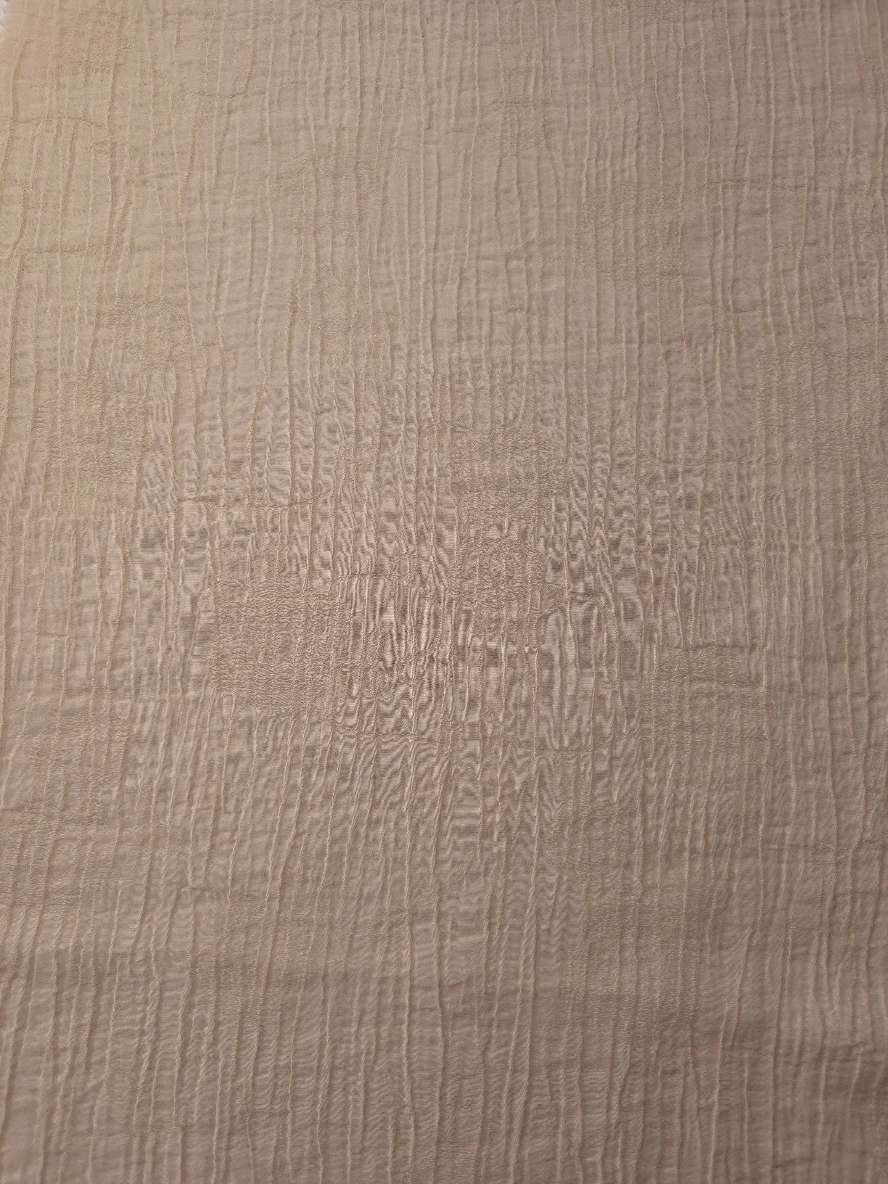 Flat view of Soft Beige Tencel jacquard with tonal petal texture for dresses and layers.
