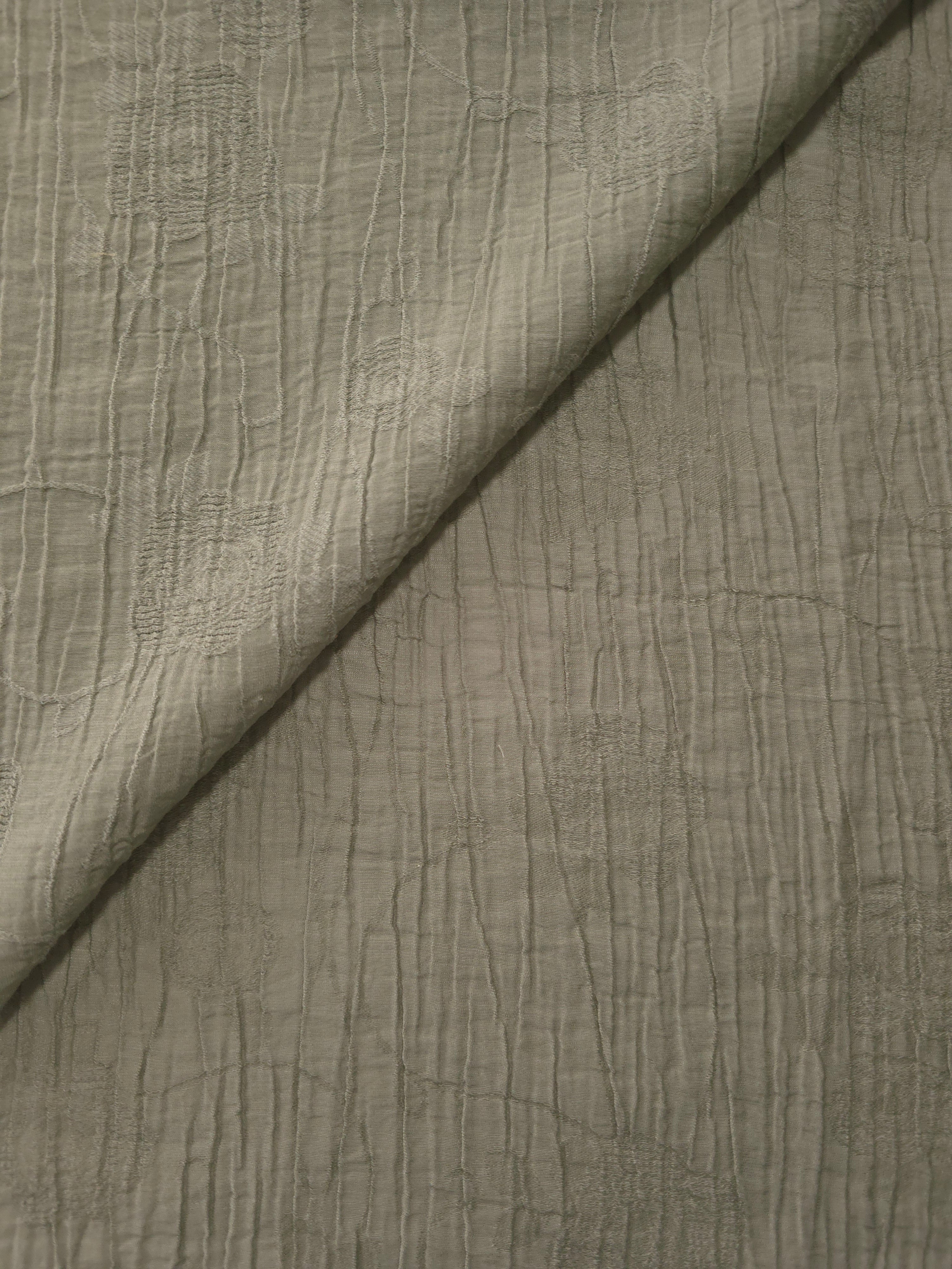 Folded Sage Green Tencel jacquard with tonal petal texture for blouse and skirt layers.