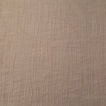 Flat view of Soft Beige Tencel jacquard with tonal swirl texture for dresses and layers.