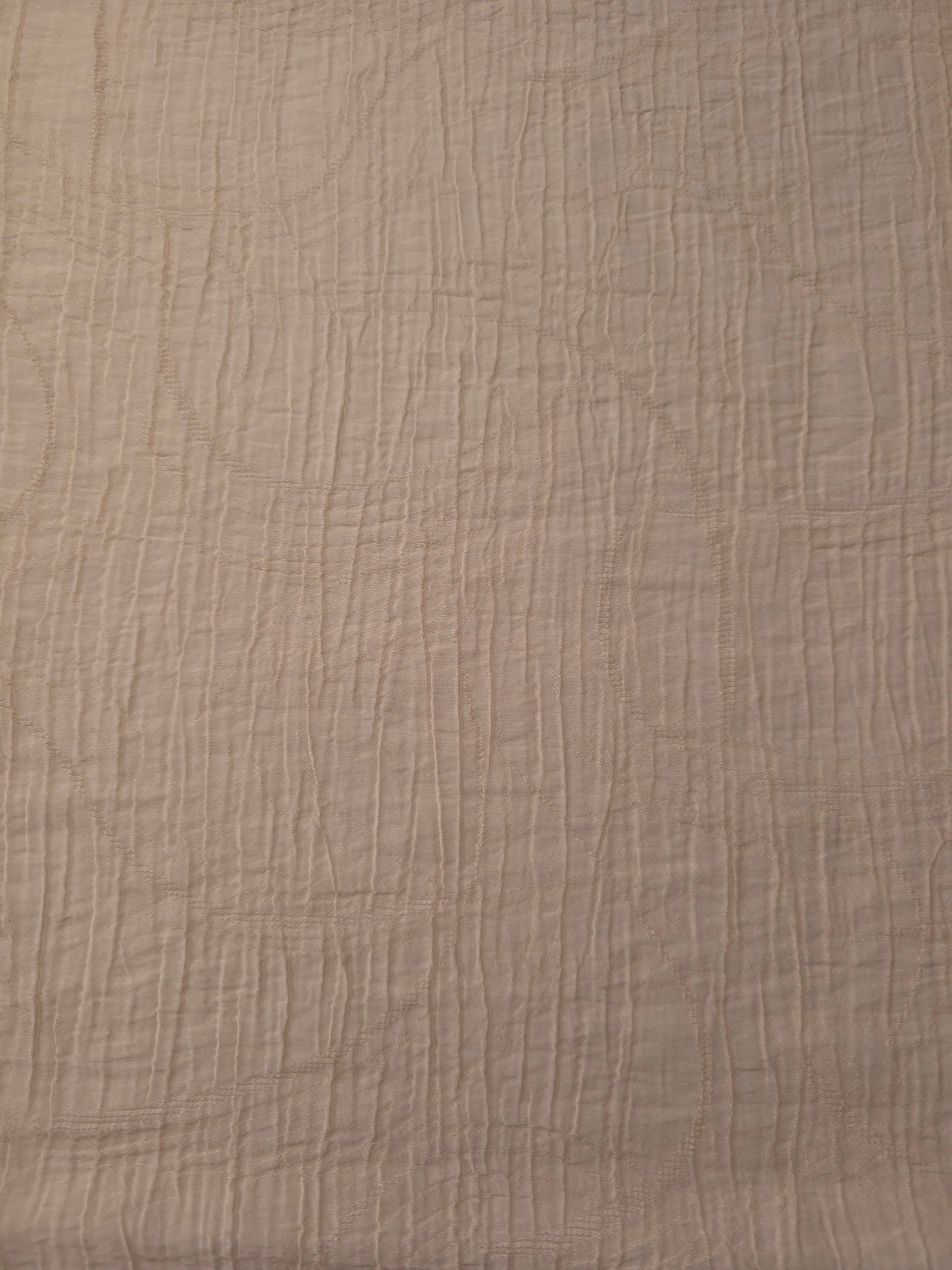 Flat view of Soft Beige Tencel jacquard with tonal swirl texture for dresses and layers.