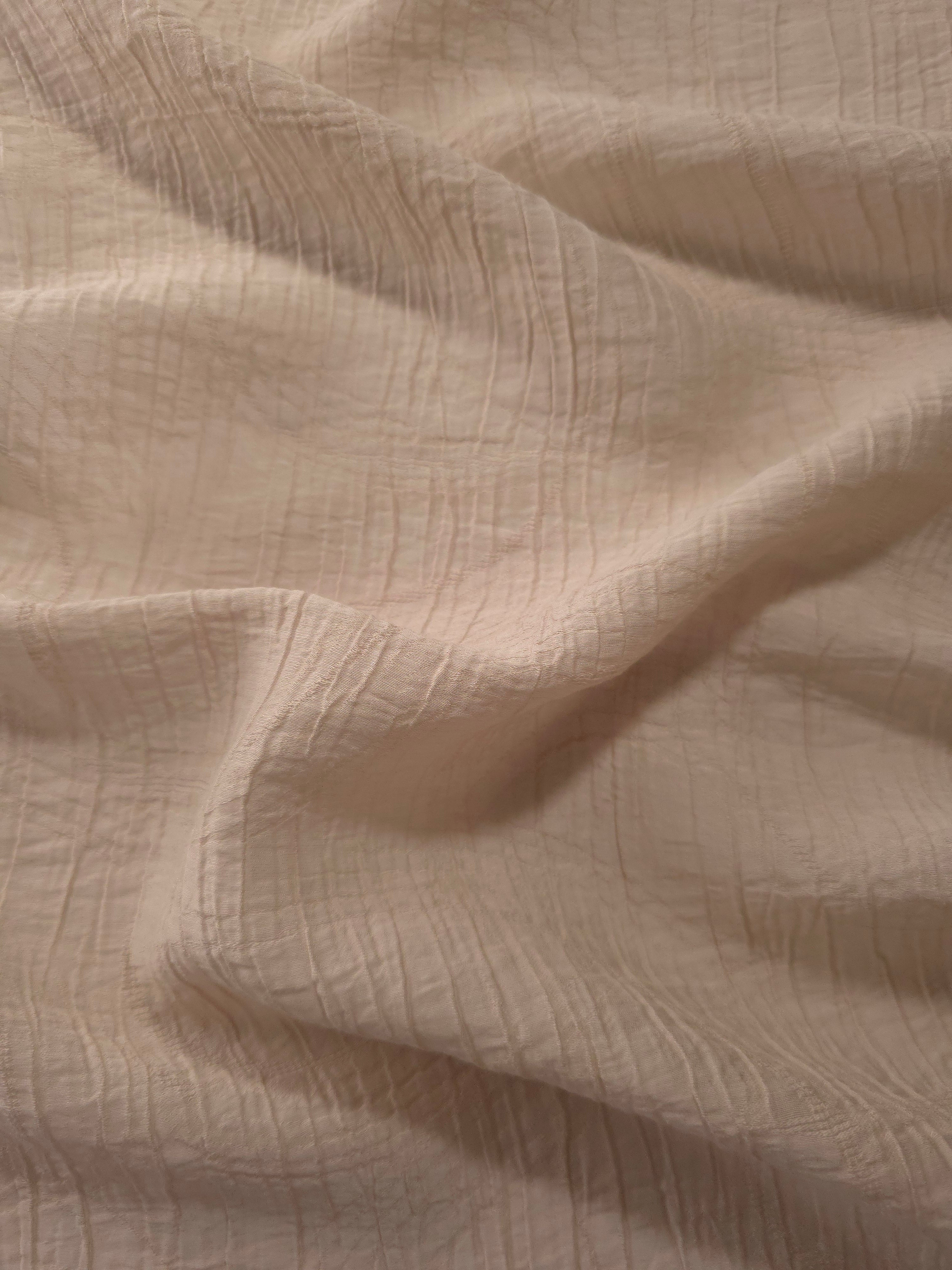 Draped Soft Beige Tencel jacquard showing airy movement for kaftans and dresses.