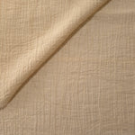 Folded Butter Yellow Tencel jacquard with tonal swirl texture for blouse and skirt layers.