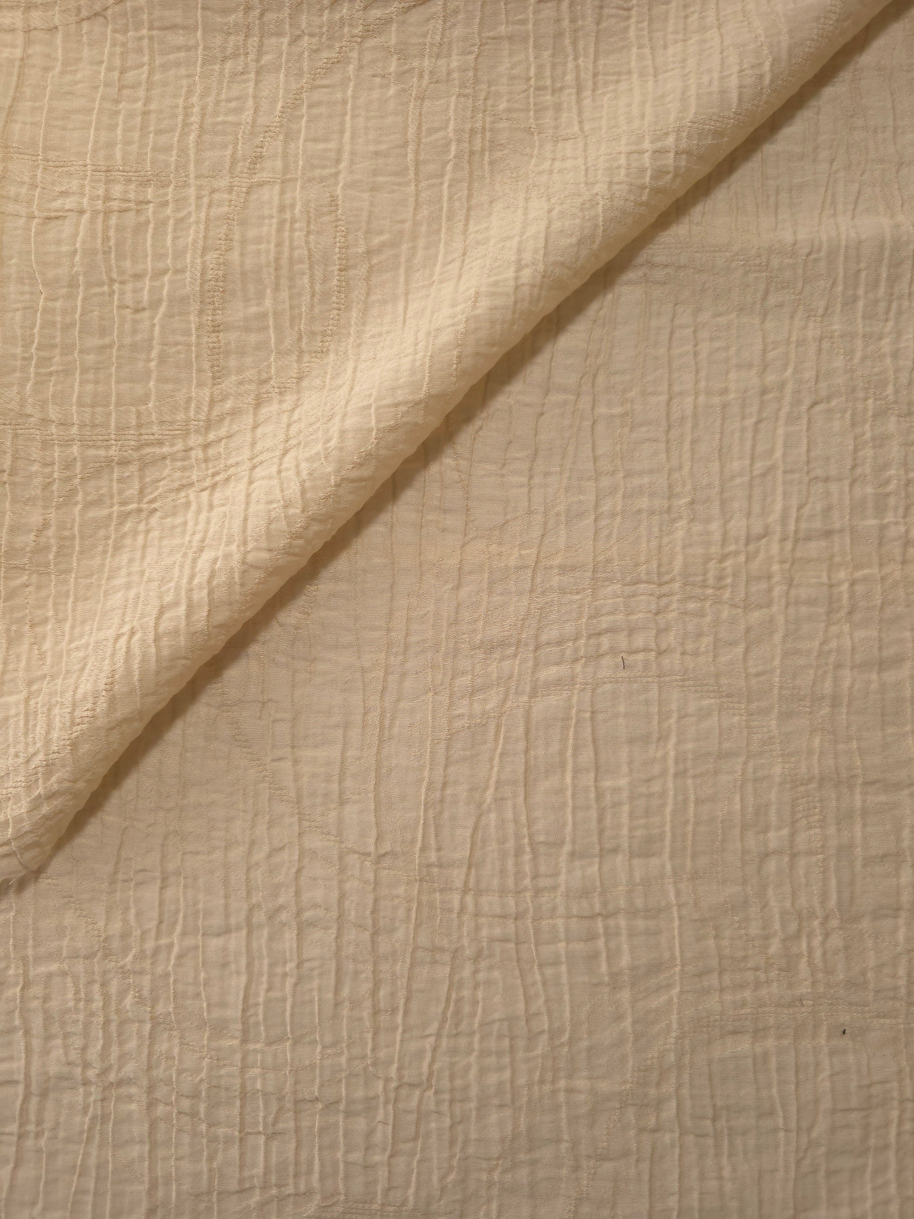 Folded Butter Yellow Tencel jacquard with tonal swirl texture for blouse and skirt layers.