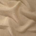 Fold detail of Butter Yellow Tencel jacquard with tonal swirl texture for dressmaking.