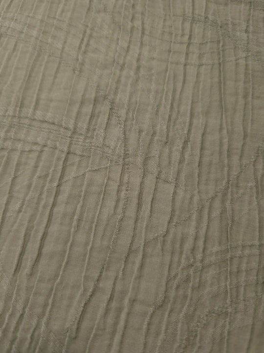 Close-up of Sage Green Tencel jacquard showing tonal swirl texture and light weave.