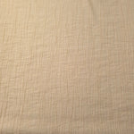 Flat view of Butter Yellow Tencel jacquard with fine root line texture for dresses and layers.