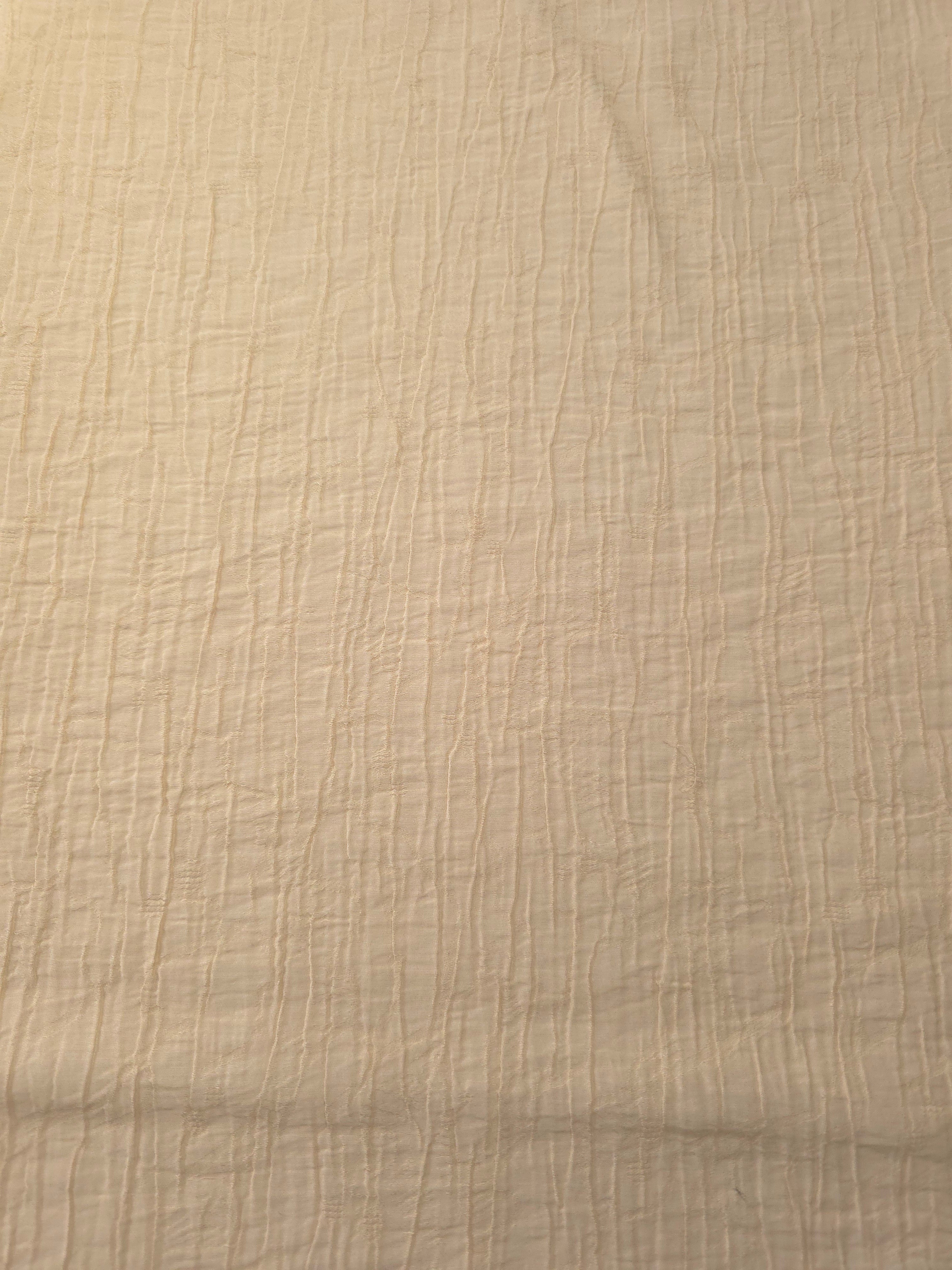 Flat view of Butter Yellow Tencel jacquard with fine root line texture for dresses and layers.