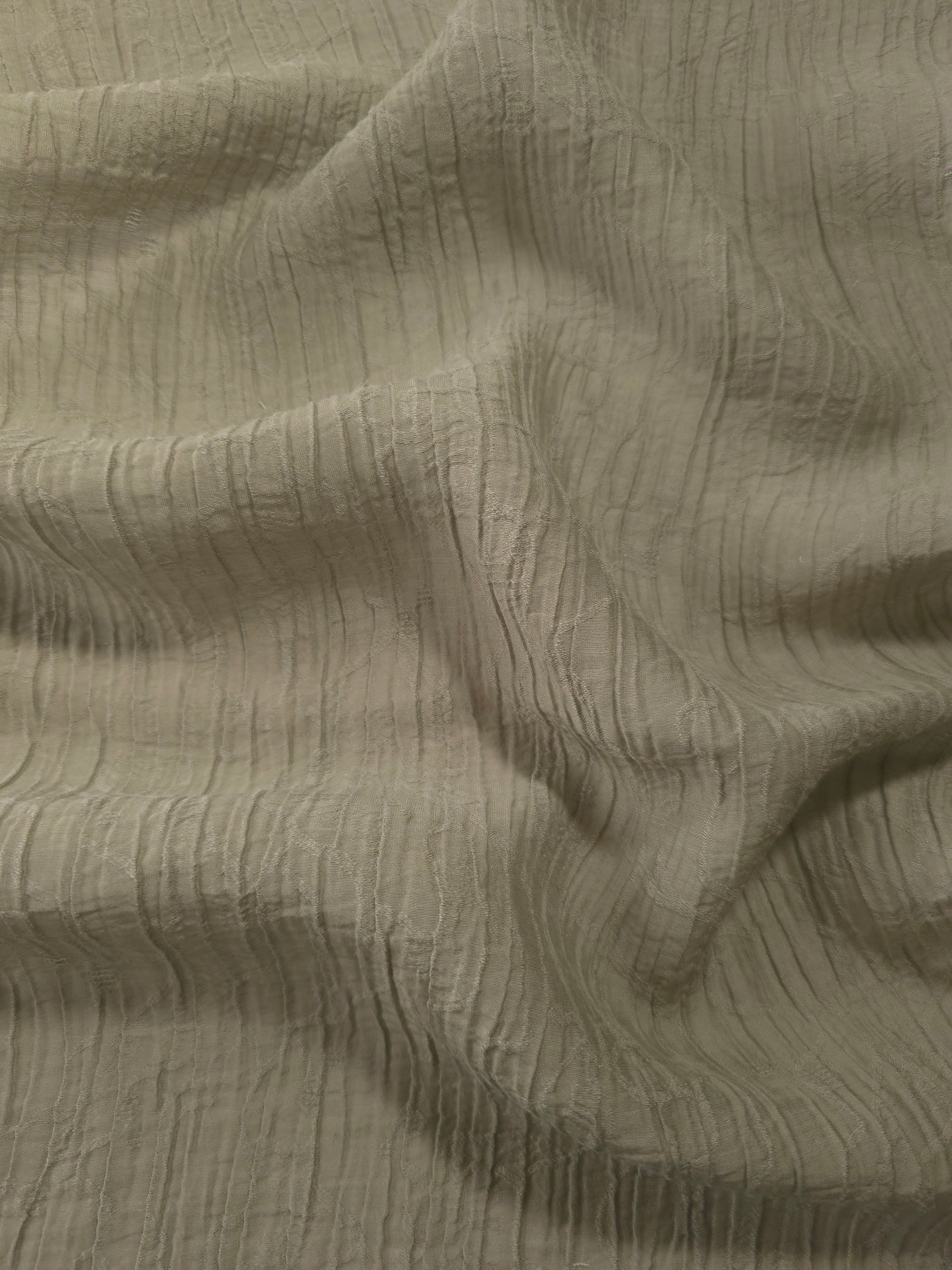 Detail view of Sage Green Tencel jacquard with fine root line texture for soft layers.